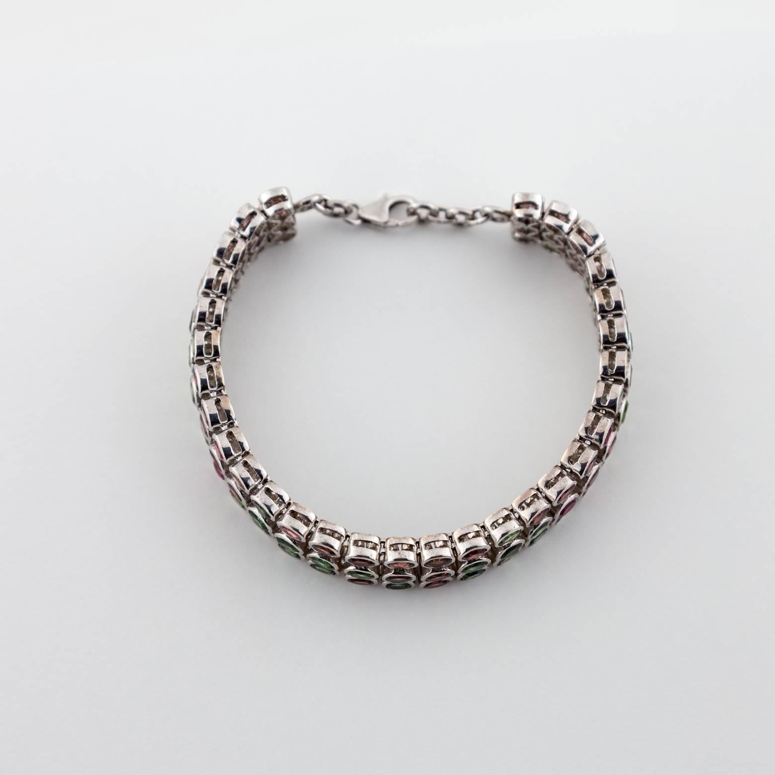 Stunning! 90 pieces of multi-colored tourmaline in varied pinks and greens. This sterling silver bracelet sparkles from across the room in dainty delicate colors that go well in any occasion. Stacked in 3's this chain-link bracelet offers