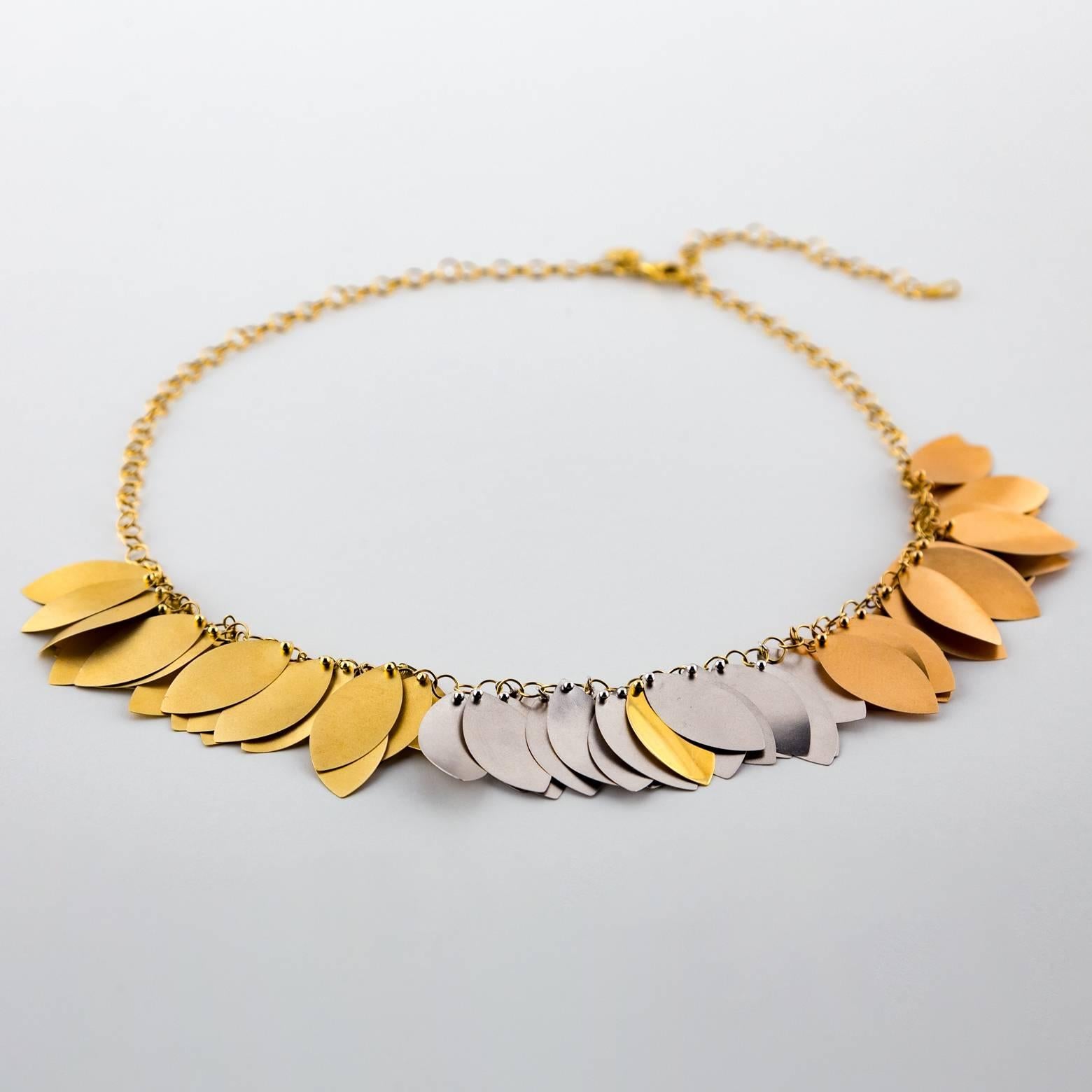 This beautiful golden leaf necklace has three shades of 18k gold and slightly twisted leaves. It dangles so elegantly and it lays around the neck as if blown by a slight breeze. The three shades of gold allow it to go with any outfit! 