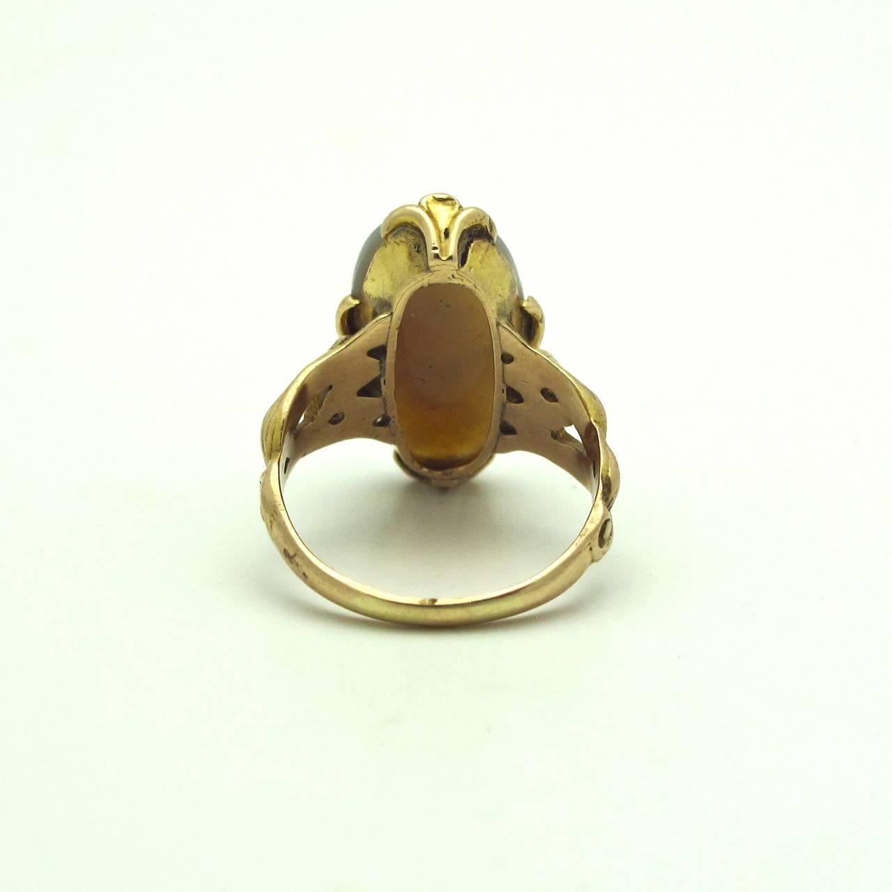 This is a beautiful large opal cocktail ring with a sparely green shine! It's a  piece that's unique and reminiscent of the 1950's. If you're going to party and want to bring out the vintage flare this is the perfect ring for you! The band is