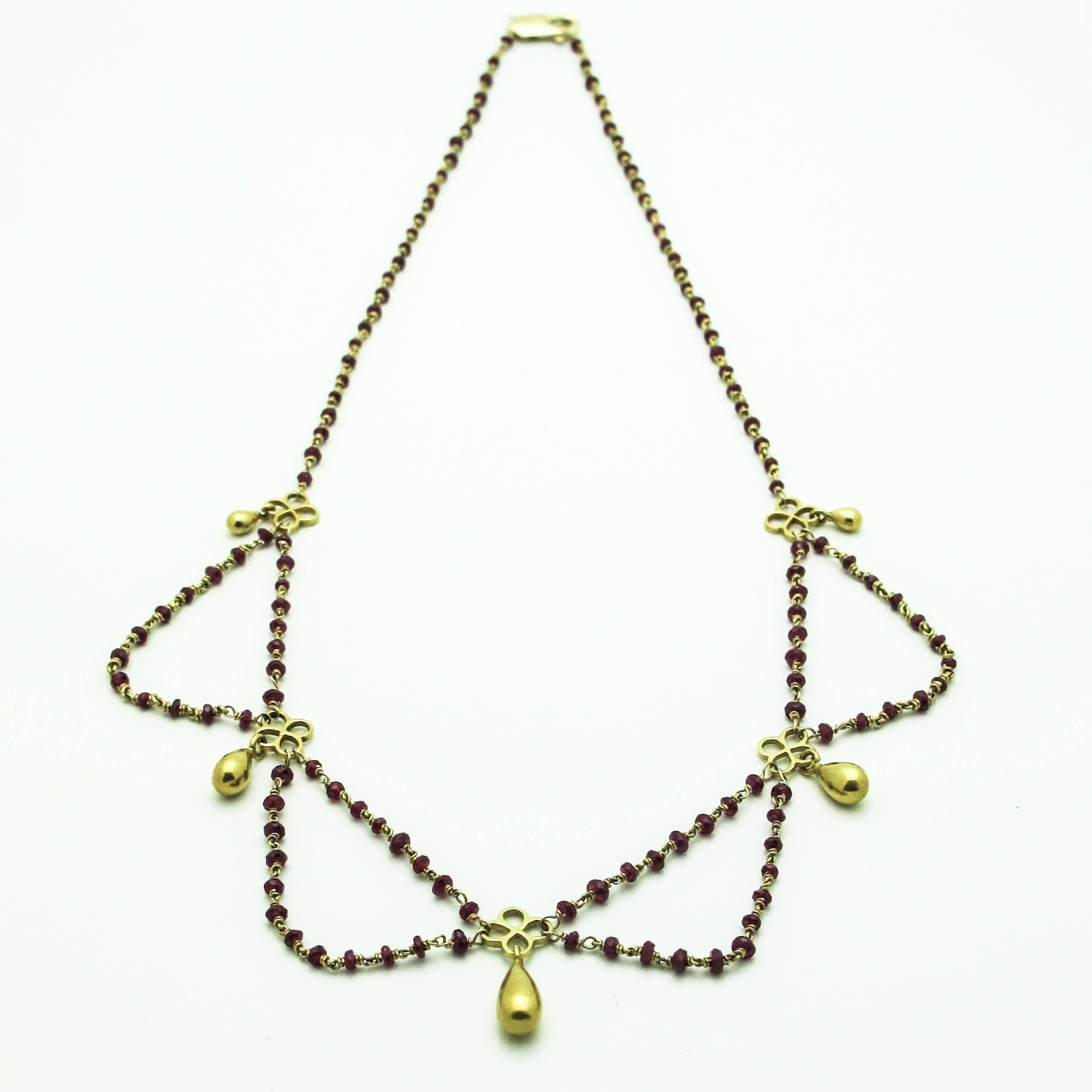 Elegant multi strand ruby necklace with teardrop pendants. Drapes beautifully on neck. Delicate and feminine design. Rich contrast between 18k yellow gold and ruby beads. 