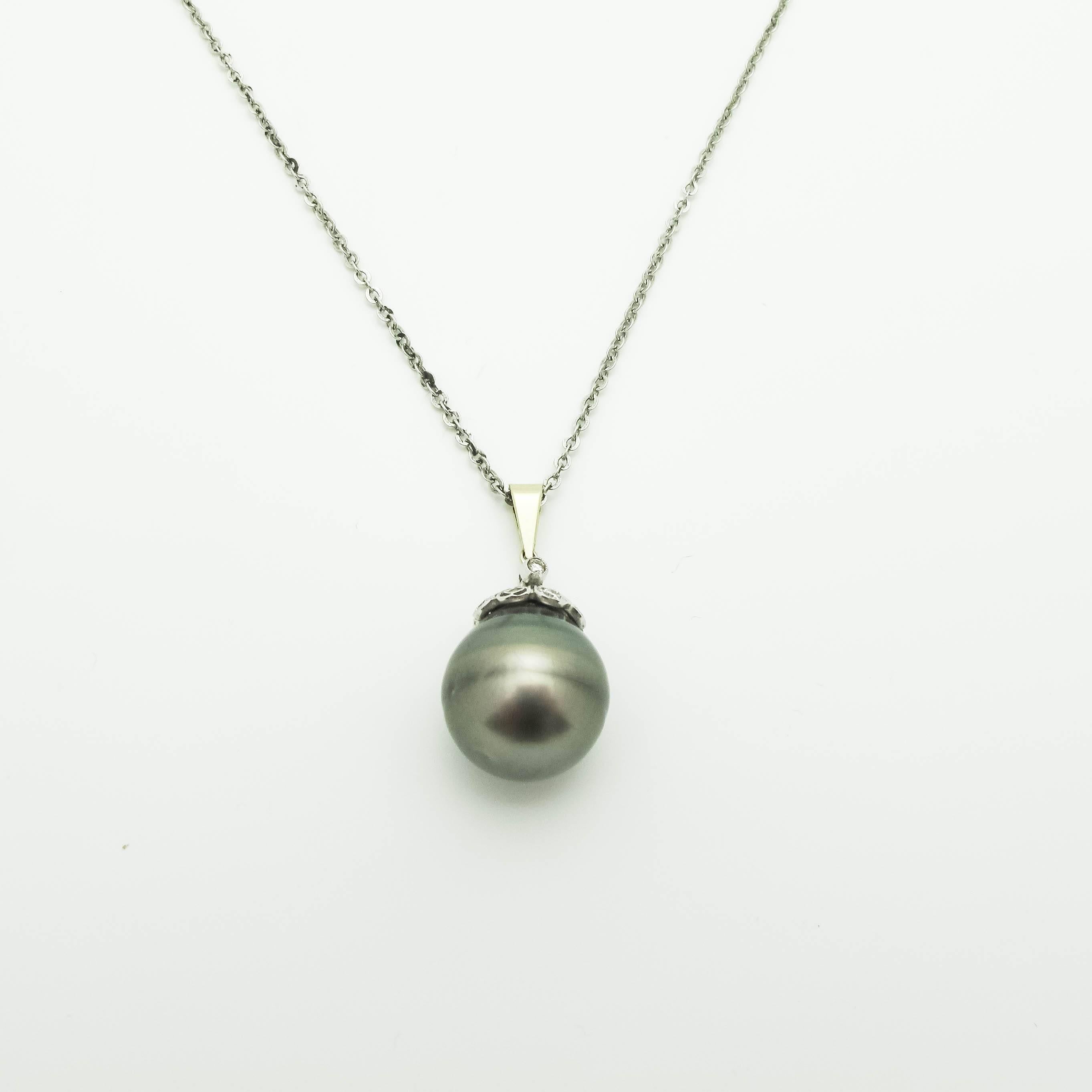 This black pearl pendant has a diamond and white gold Pave flower cap and is absolutely stunning. Greys and various shades of greens all work together to reflect whatever you are wearing. The 16