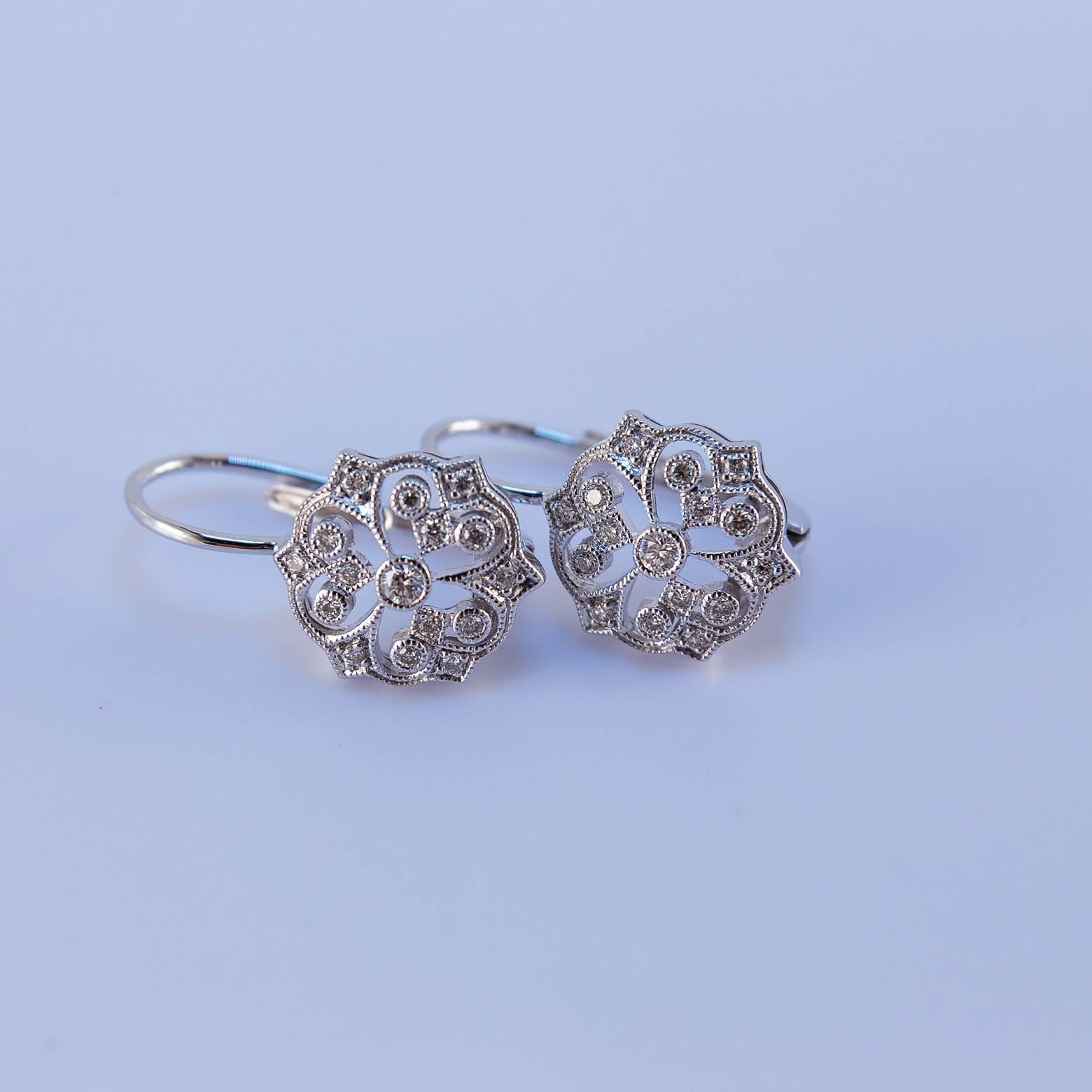 Beautiful and elegant diamond earrings with filigree and 14K white gold. These earrings are very intricate and detail-oriented with an extra sparkle. The white gold is absolutely stunning and acts to reflect the clarity of the diamonds. 
