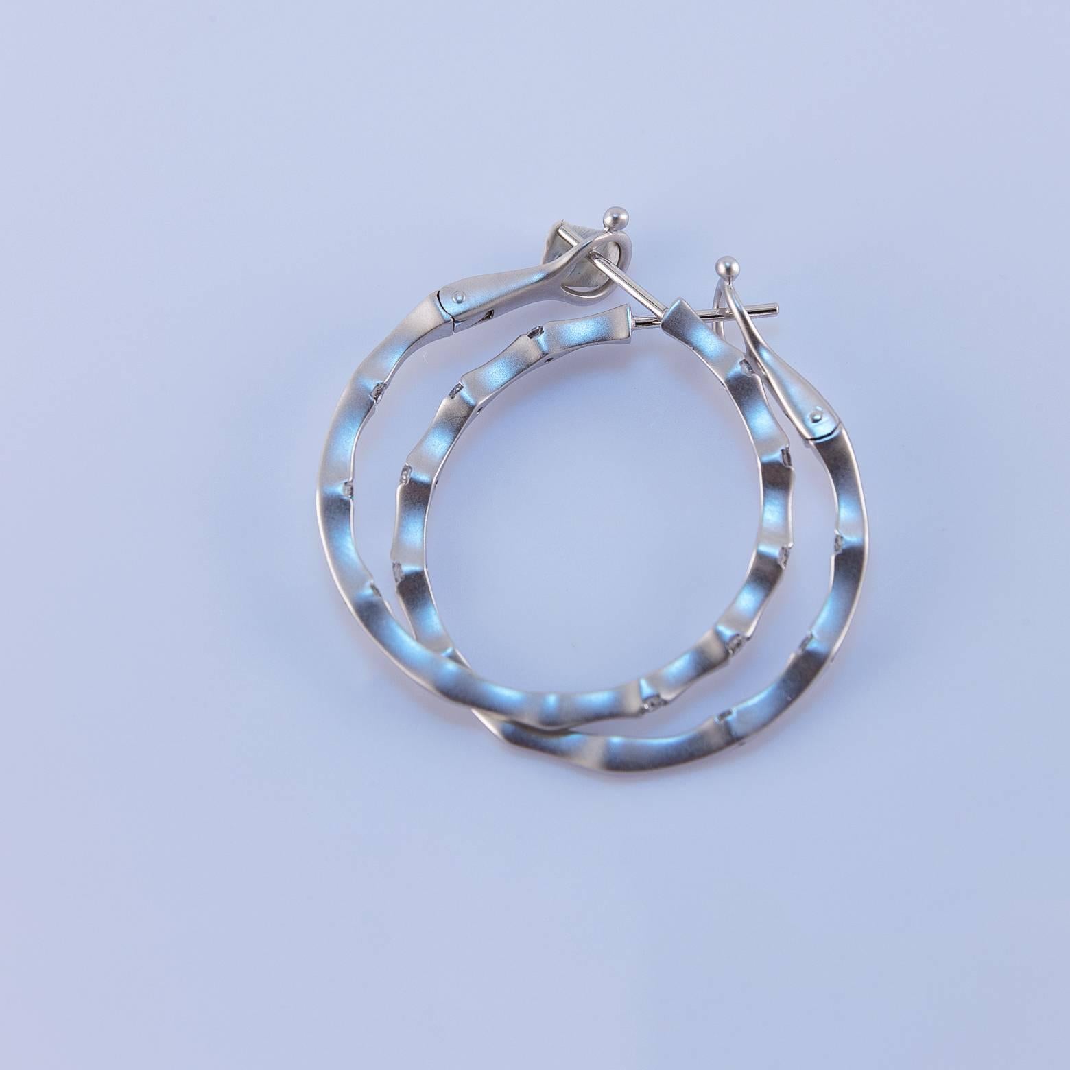 These stunners have 16 diamonds 0.50 ct diamonds.The bamboo design is free flowing and modern which makes these hoops so original. There is a safety clasp on the back post so you can wear these and 'dance the night away' or swim in the ocean in that