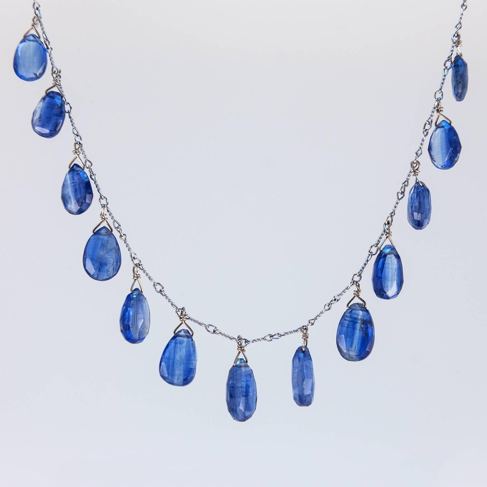 These 13 beautiful royal blue kyanite briolettes glow while they hang wonderfully from a 14K white gold chain. The brilliance and texture of these briolettes is astonishing as they rest easily around your neck with youth and ease. Kyanite is a