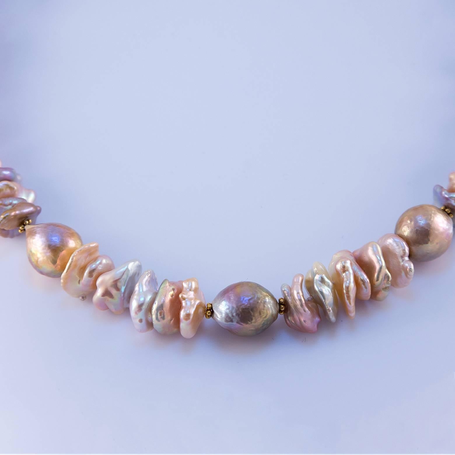 Heavy, Beautiful, Substantially Stunning Fresh Water Pearl Necklace. It has so many shades of pinks, whites, and greys that it is absolutely a gorgeous statement piece! It's elegant and royal and the complexity of the exquisite pearls makes it one