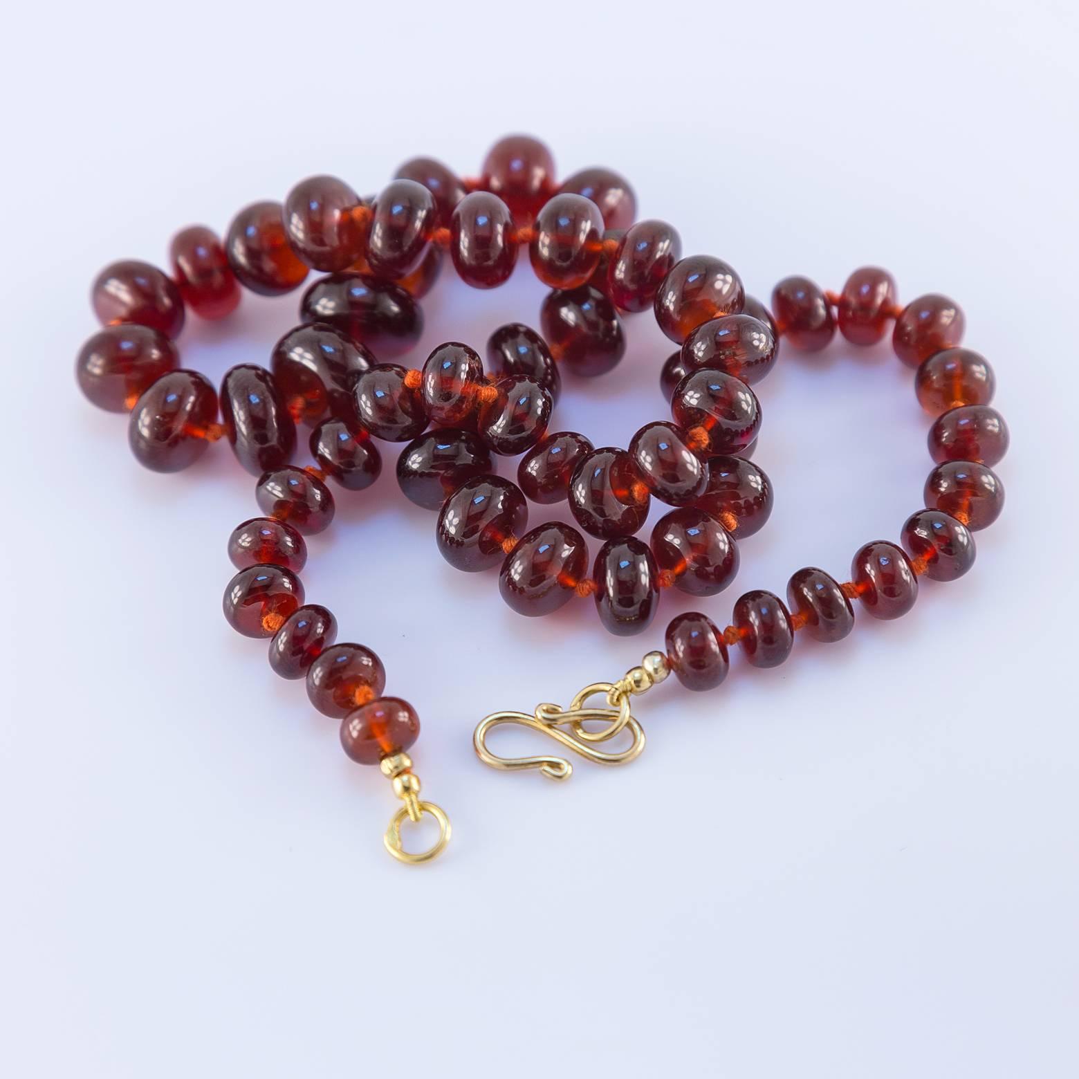 This is a rare and beautiful large garnet necklace that is classic and timeless. The graduated beads of rich garnet have a smooth round quality that akin to a fine cabernet. The deep crimson garnet has a great weight to it as it rolls against the