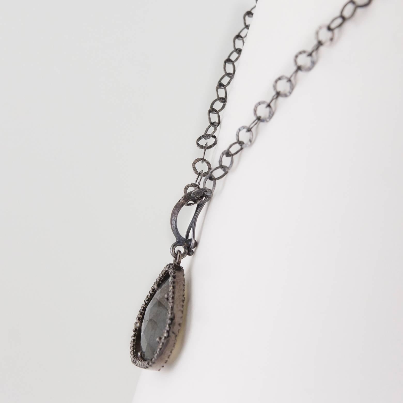 Labradorite and Diamond Oxidized Sterling Silver Pendant. This beautiful, iridescent, gorgeous labradorite pendant is surrounded with a diamond glow and shines in every angle. This exquisite piece of labradorite reflects grays, greens and blues and