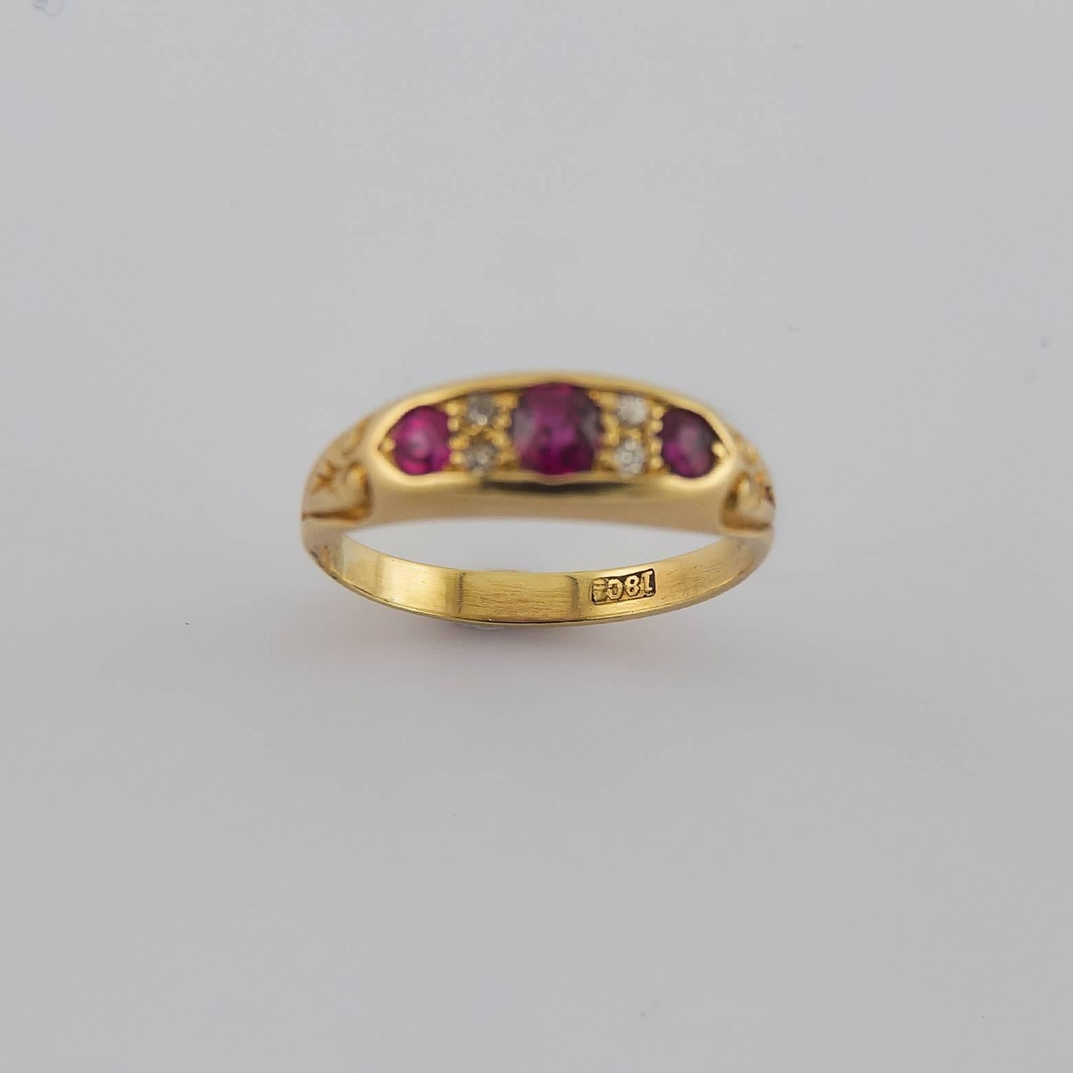 Romantic and stunning Ruby and Diamond Ring in 18K Yellow Gold. This antique ring was hand made in 1910 and is in excellent condition. 4 tiny diamonds add elegance and charm to the bright red rubies and the design is a true timepiece classic to this