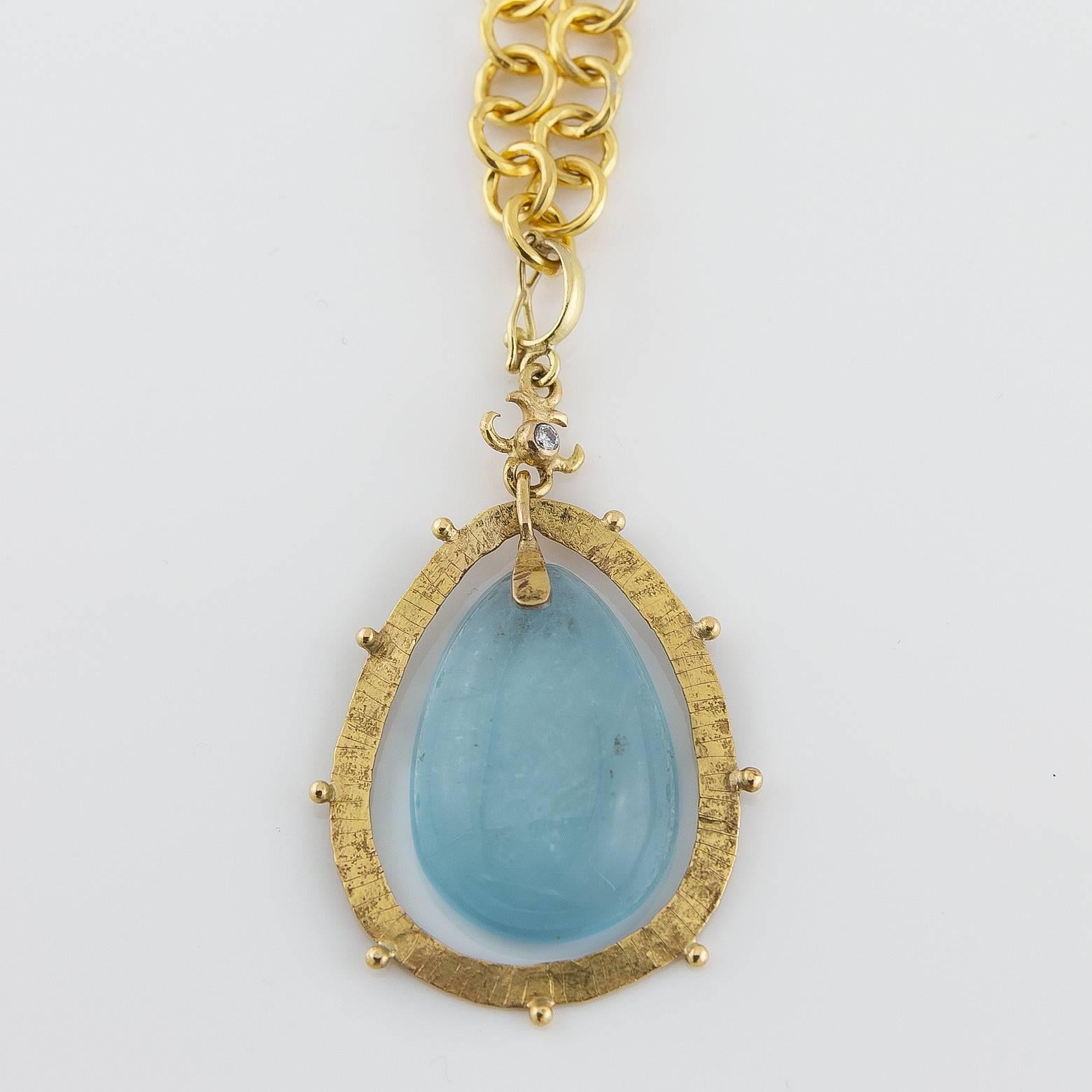 This is a large gorgeous aquamarine pendant enhanced with a tiny diamond on top for added flare. The sparkle to this milky aquamarine piece is absolutely stunning and the texture to the 18K yellow gold is fit for a goddess. Every part of this piece
