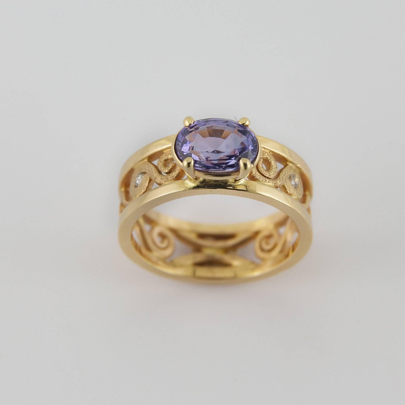 This light purple blue indigo sapphire spiral ring is dazzling! The boldness of the band is complimented by the textured spirals and adds such luxury to a stunning one of a kind piece. The sapphire is 2.14 carats and the 2 diamonds on the side give