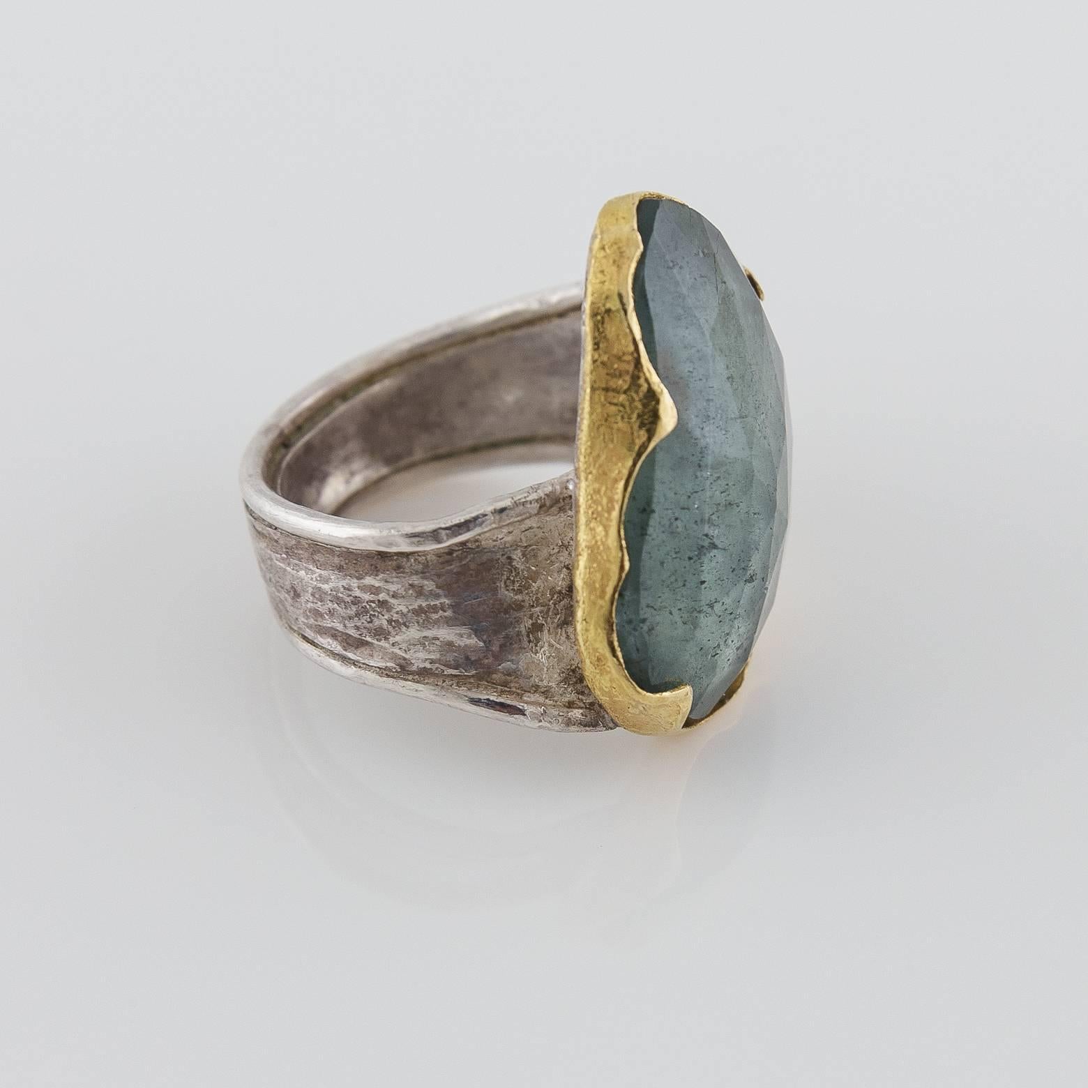 This beautiful moss aquamarine two-toned ring was handmade in the San Francisco Bay Area. It is both sterling silver and 18K yellow gold. It has an ancient and artistic feel to it and the stone is absolutely unique and gorgeous with a rare pinkish