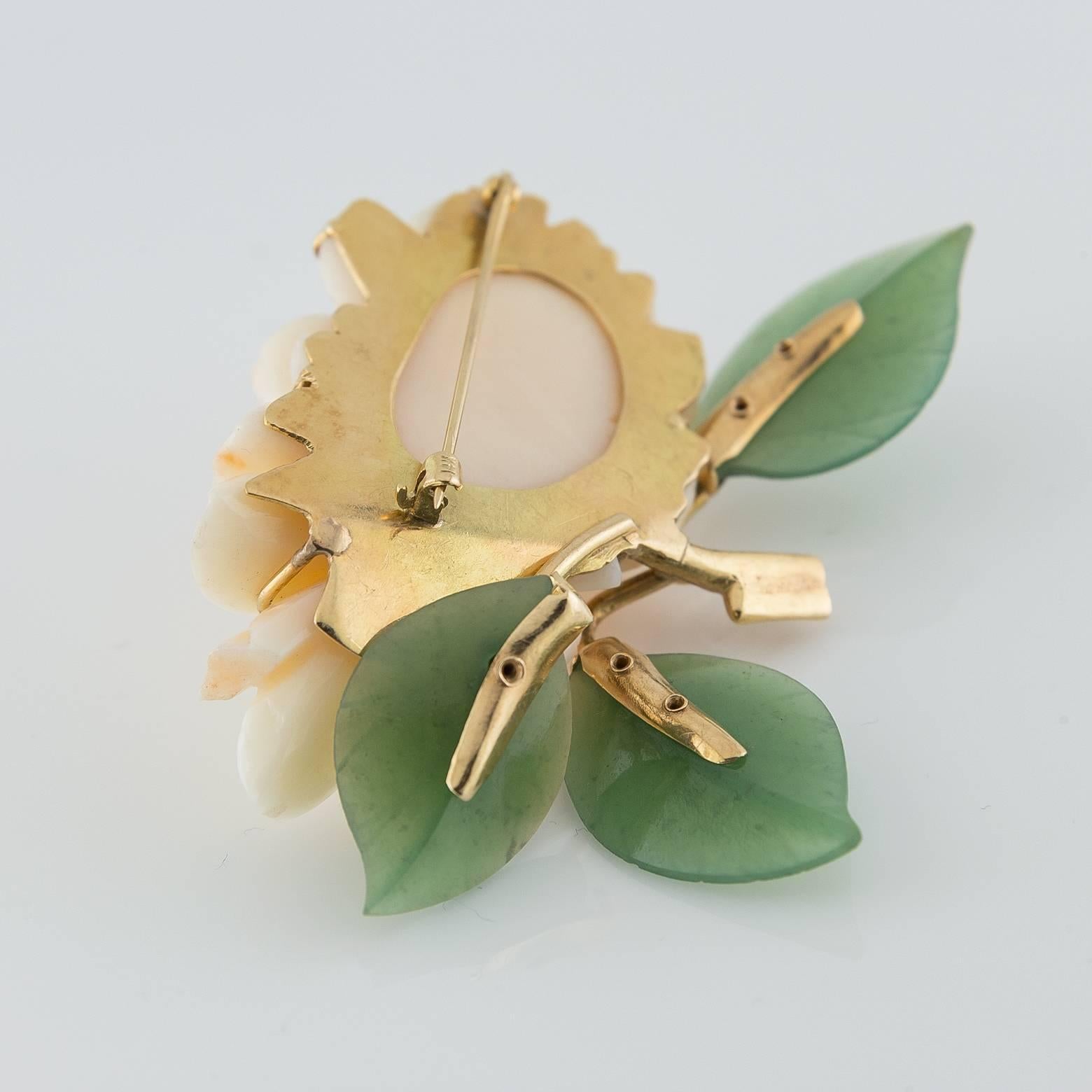 This stunning, soft and elegant pin in of the finest quality and has a delicate innocence about it. The color of the flower is a light ivory with a hint of peach on the larger petals. The branches are artfully sculpted out of 14k gold. 