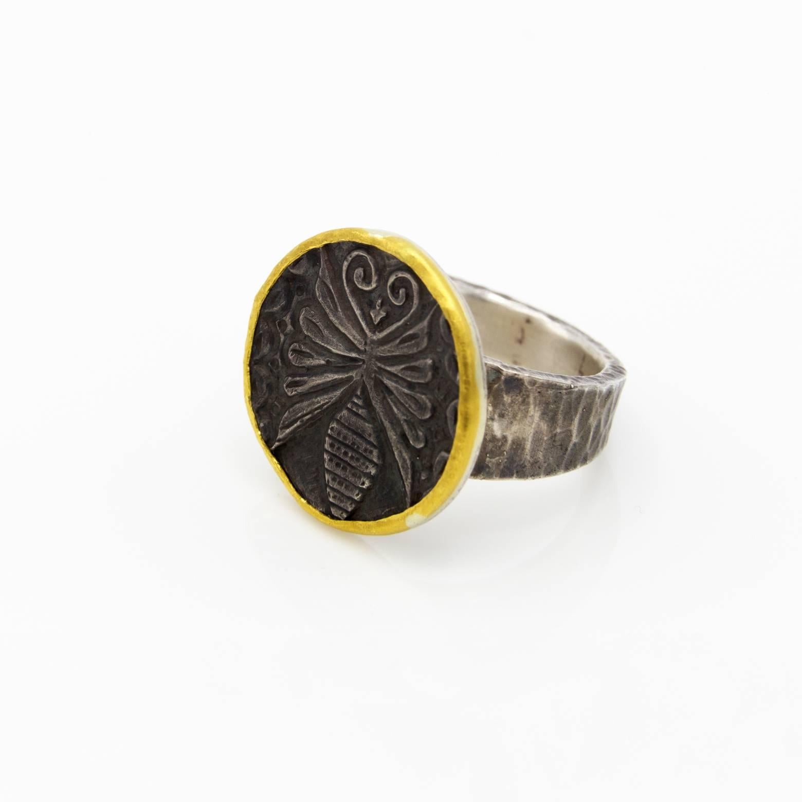 Butterfly, bugs and insects! This beautiful handmade ring looks like a thick coin with a gold border and a gorgeous butterfly on top with swirls and wings. The bottom of the butterfly almost looks like a beehive and the detail in the texture looks