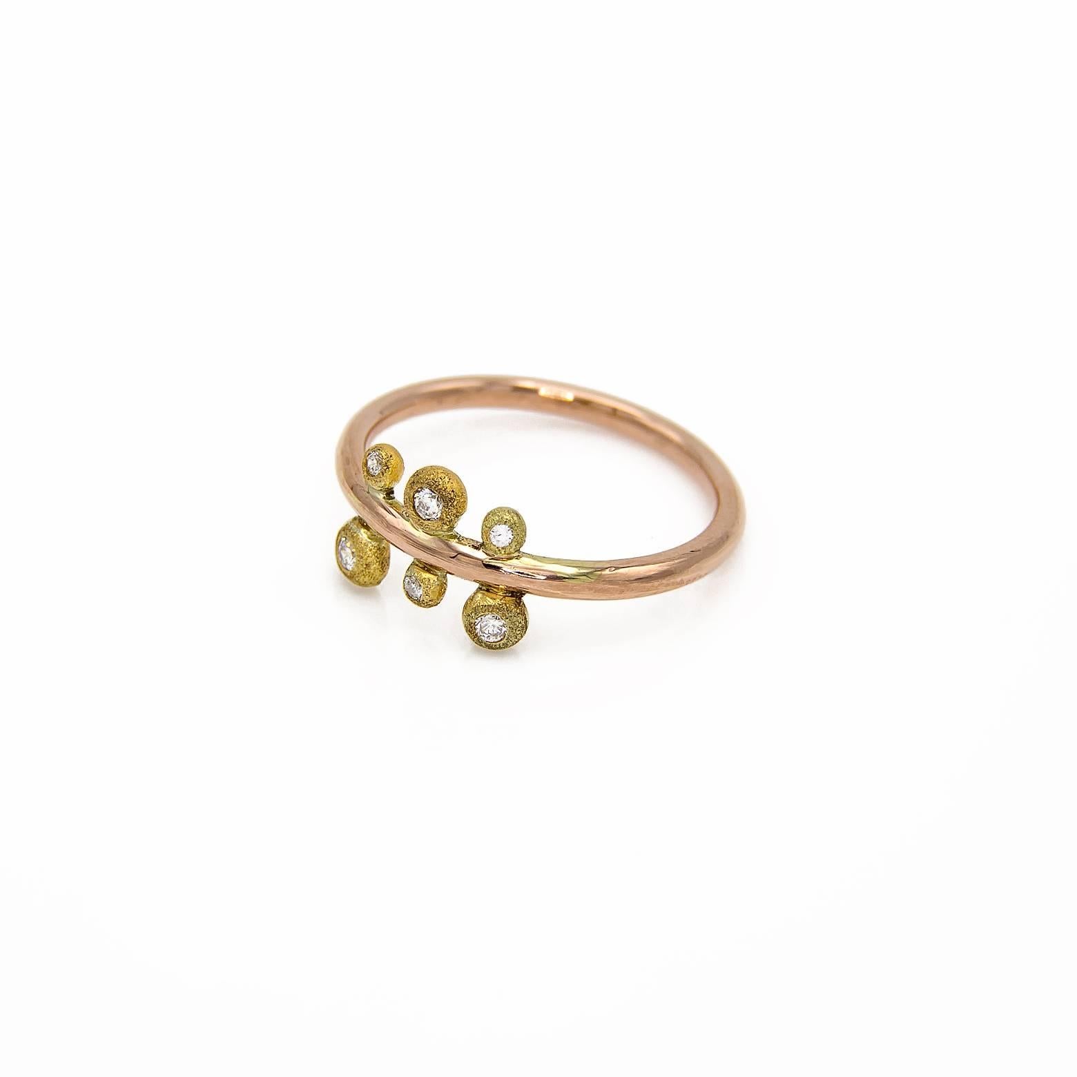 This fanciful ring is a combination of yellow and rose gold. The 'fern' design is accented with 0.08 tw diamonds set in textured yellow gold on a smooth band of rose gold. The size is 6.5.The sparkle and whimsy of this ring is striking!!