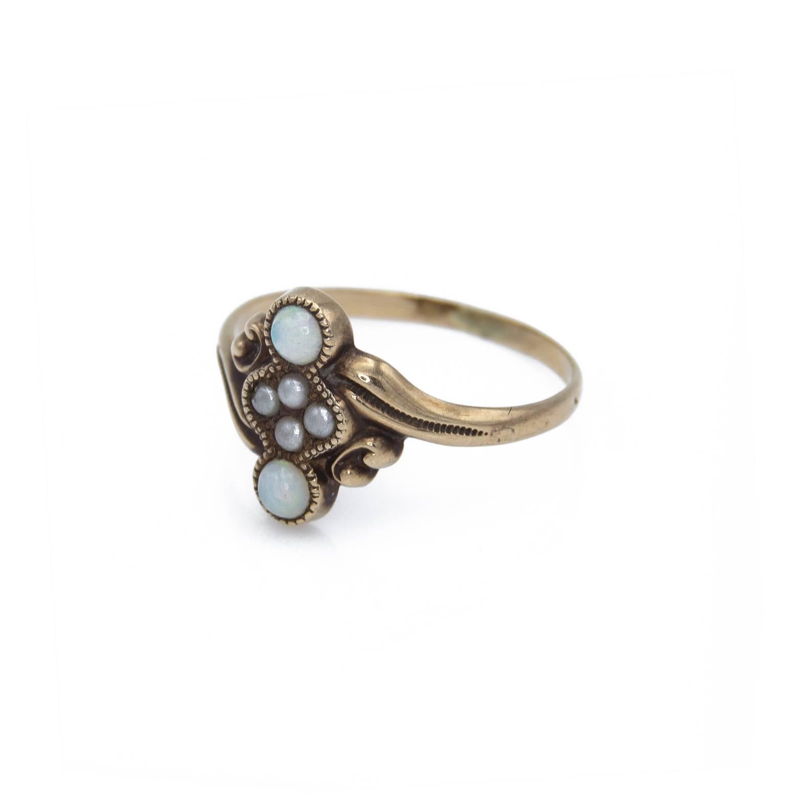 This delicately set opal and freshwater pearl ring has a beautiful swirl antiqued in 10k. The overall effect is sweet and beautiful ....The perfect gift for a young woman.