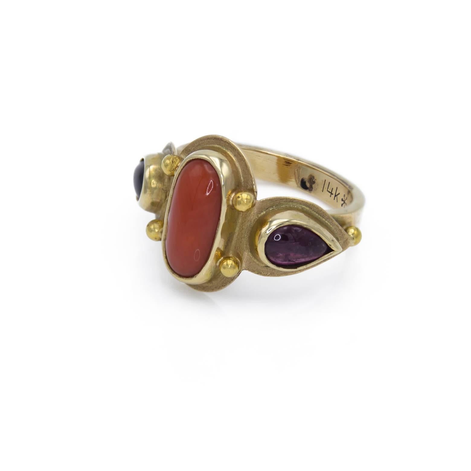 This beautiful 3 stone ring is adorned with two pear-shaped garnets and a lovely creamy orange coral in the middle. It's very romantic and regal and exudes and air of strength to it. A unique and wonderful gold ring size 5.75
