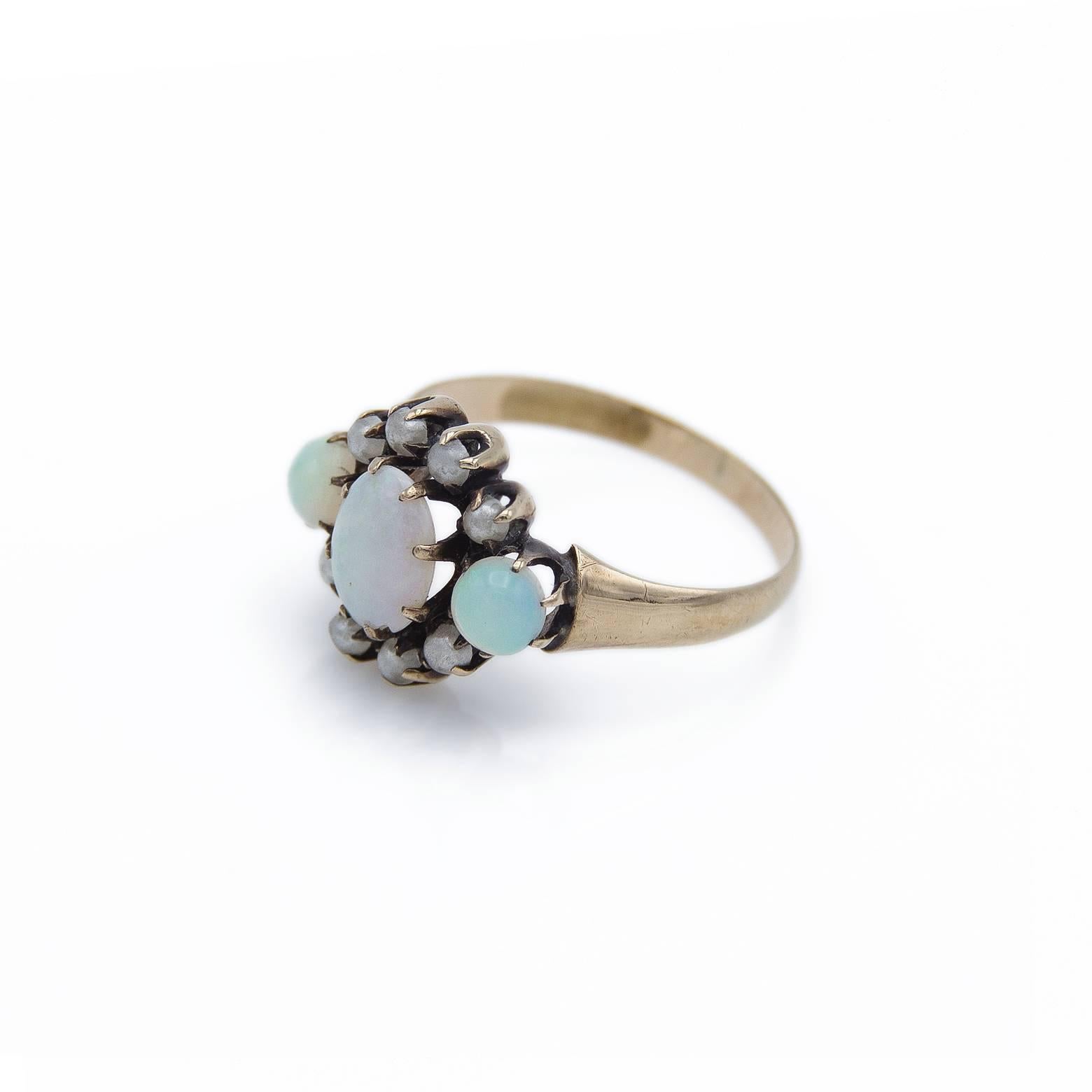 Antique and Artisan Art Nouveau Opal and Natural Pearl Ring. This ring is elegant and austere with bright glittery opal centerpiece and glowing opals on the sides. The natural pearls on the top and bottom give it the classical flower shape