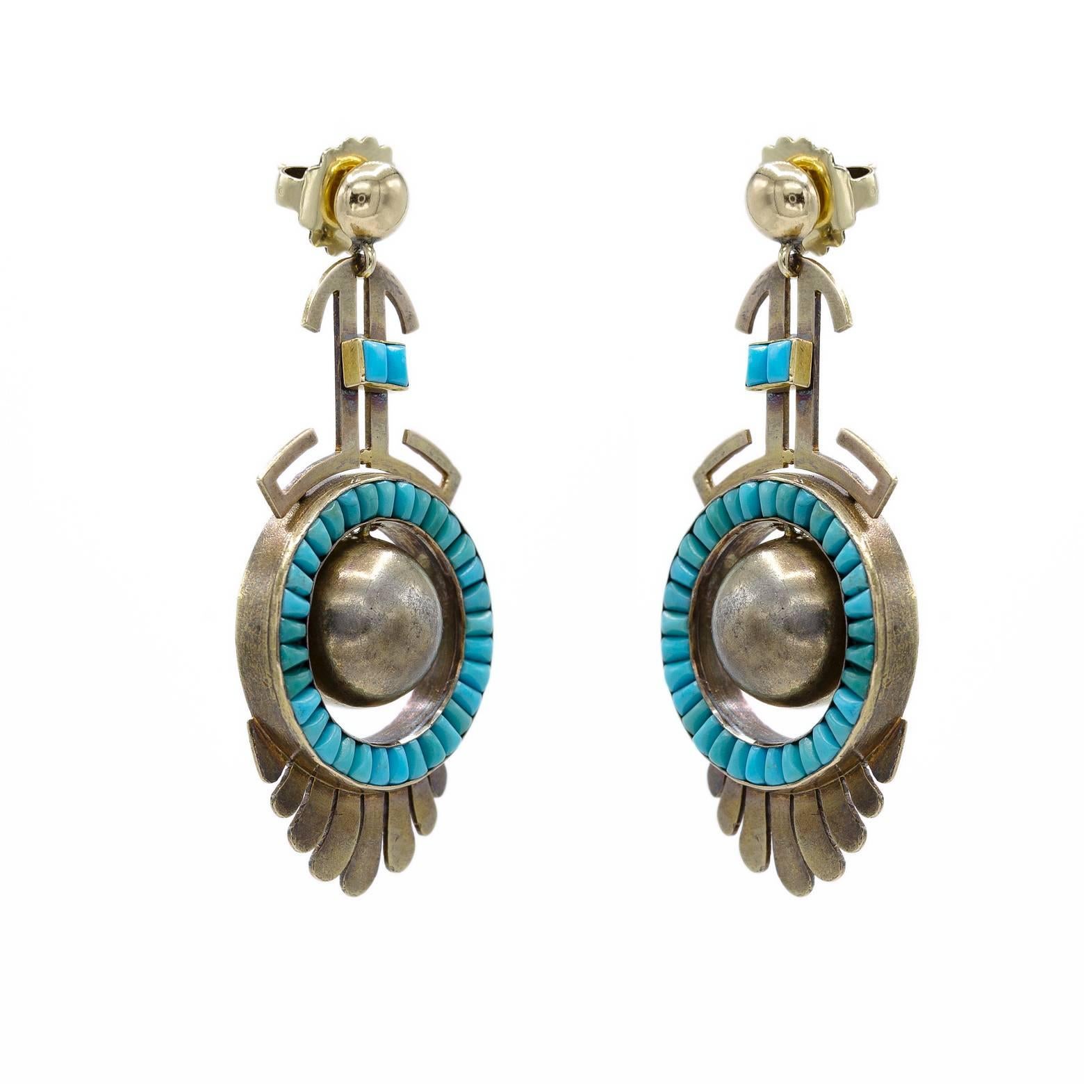 These unique gold and turquoise earrings dance from the gold posts in abstract images as if from the deep desert. The movement swings and the spheres sway giving these artsy earrings freedom to express the hand work of the many inlaid turquoise
