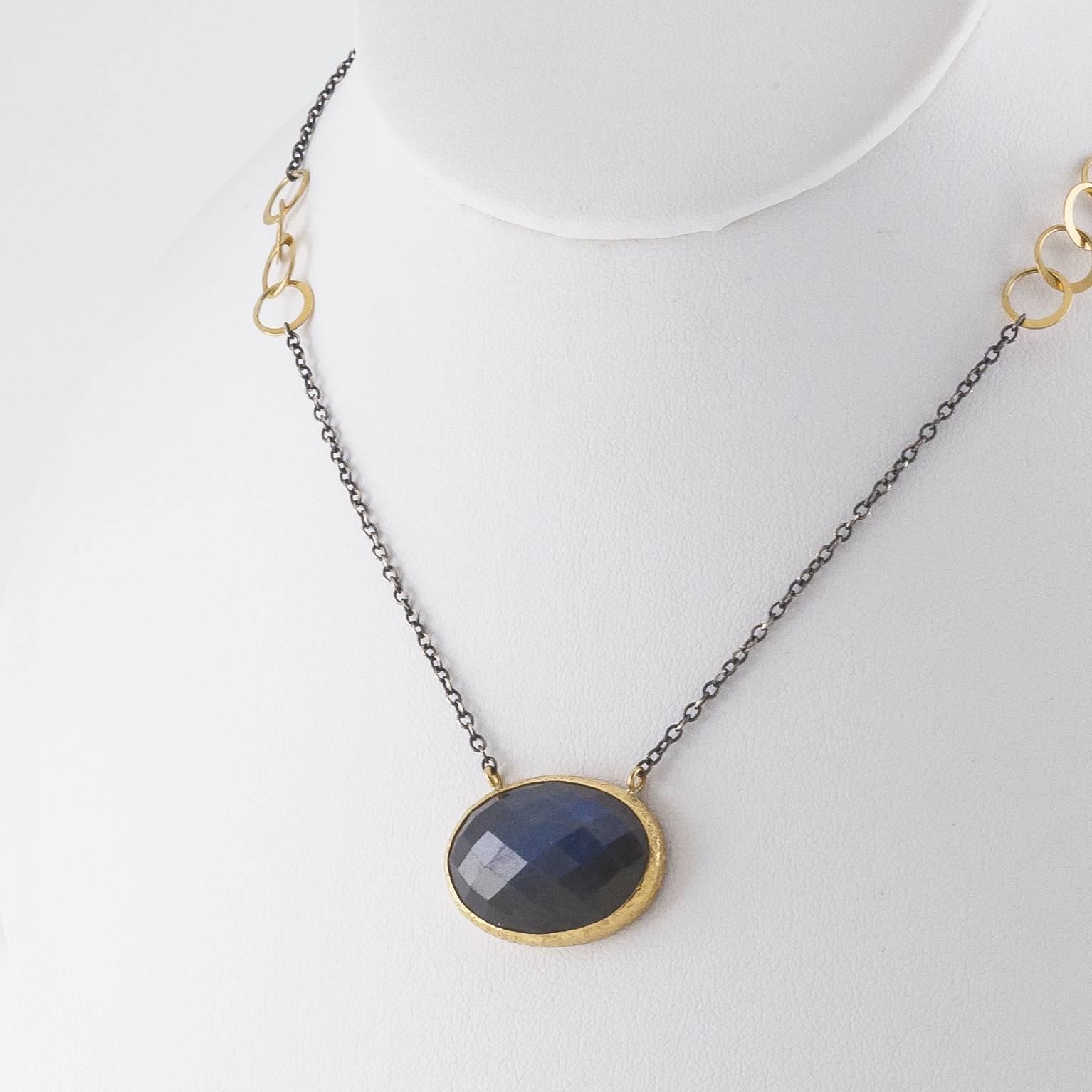 This beautiful and unique piece was hand made in the San Francisco Bay Area.   Unique and exquisite with a two toned chain in yellow gold and oxidized sterling silver this piece is mesmerizing. The gold bezel is hammered and this piece of