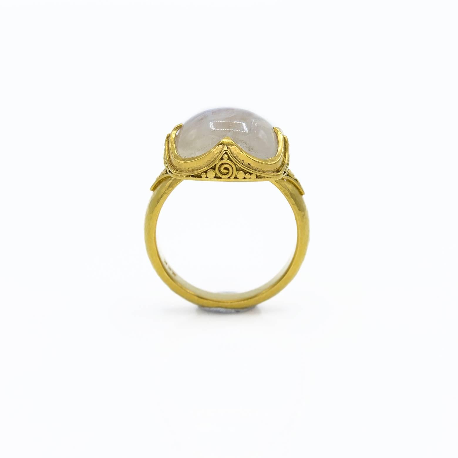 This stunning ring has detailing that perfectly showcases the beauty of the fiery moonstone. The band is hammered to bring out the warm glow of the 22k gold. The size is 5 3/4.  