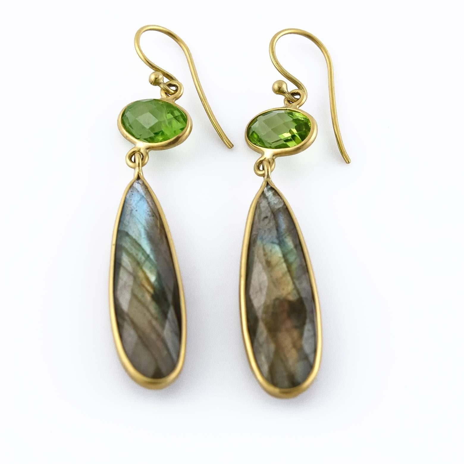 These elegant and sophisticated earrings have bright green peridot eyes that glimmer and shine atop long tear drop labradorites. High quality labradorites, rose cut with the high reflective labradoressence that is so characteristic of this marvelous