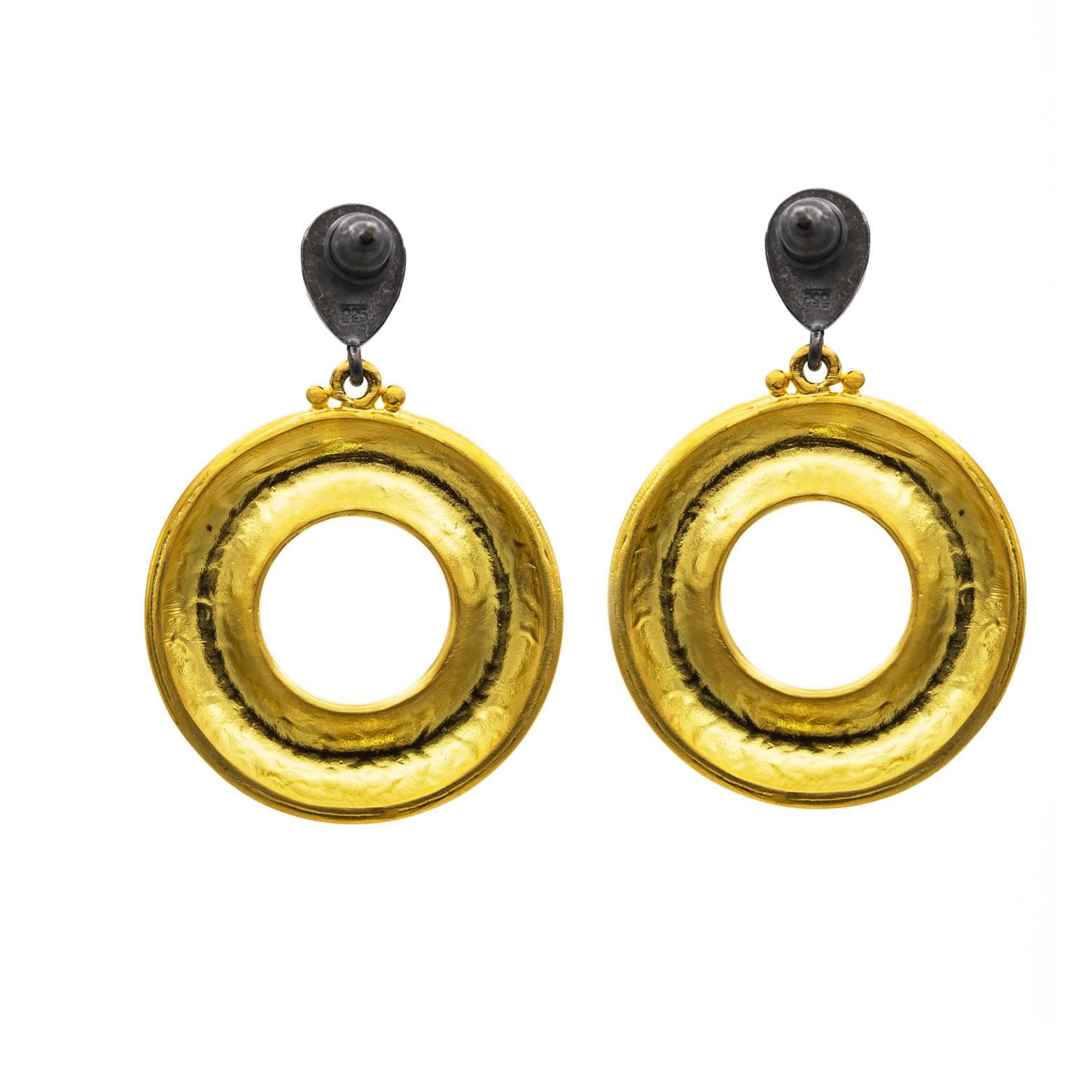 These gorgeous extra thick gold vermeil large hoop earrings dangle from an oxidized sterling silver drop and swing with your unique movement. The hammered texture gives them an elegance and shine that absorbs and reflects the subtlest of light. It's