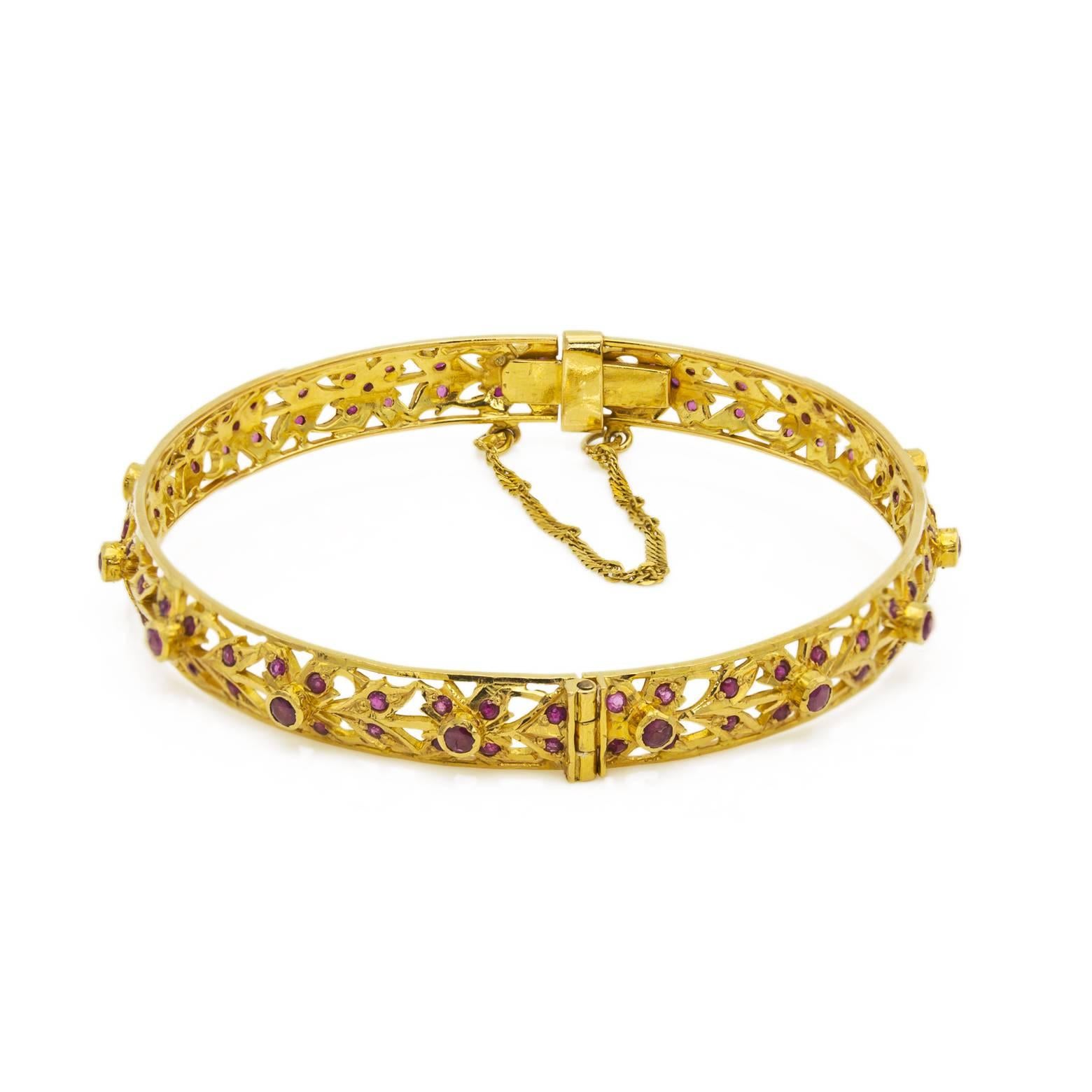 This bracelet is so delicately detailed it almost looks like-lace with a glowing 22K yellow gold sheen and excellent craftsmanship. The bright rubies in a floral design stand out and sing while the strength and authenticity of this piece was built