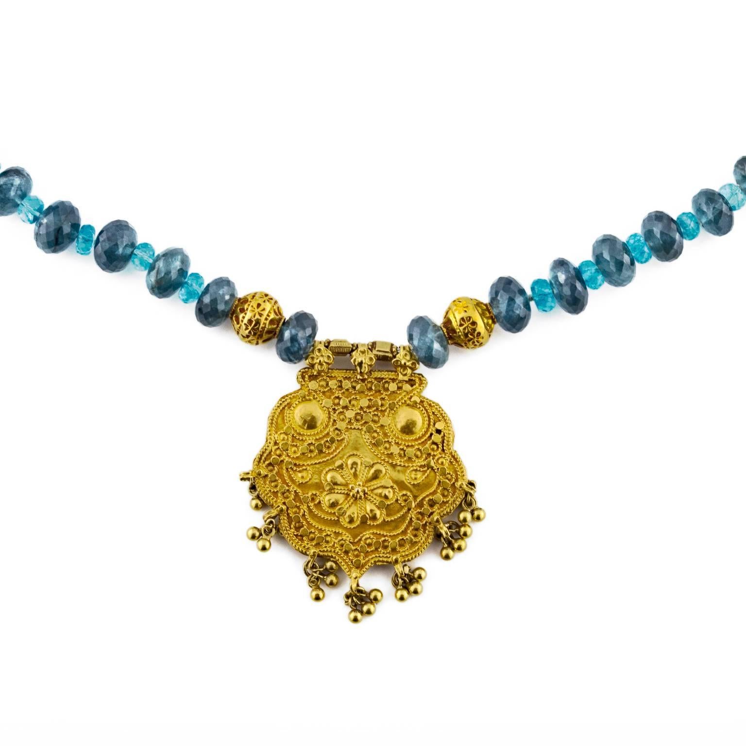 This beautiful combination of hues in moss aqua and apatite faceted beads sparkle and dazzle with a delicately carved and tasseled 18k medallion and accent beads. Easy to wear and layer....