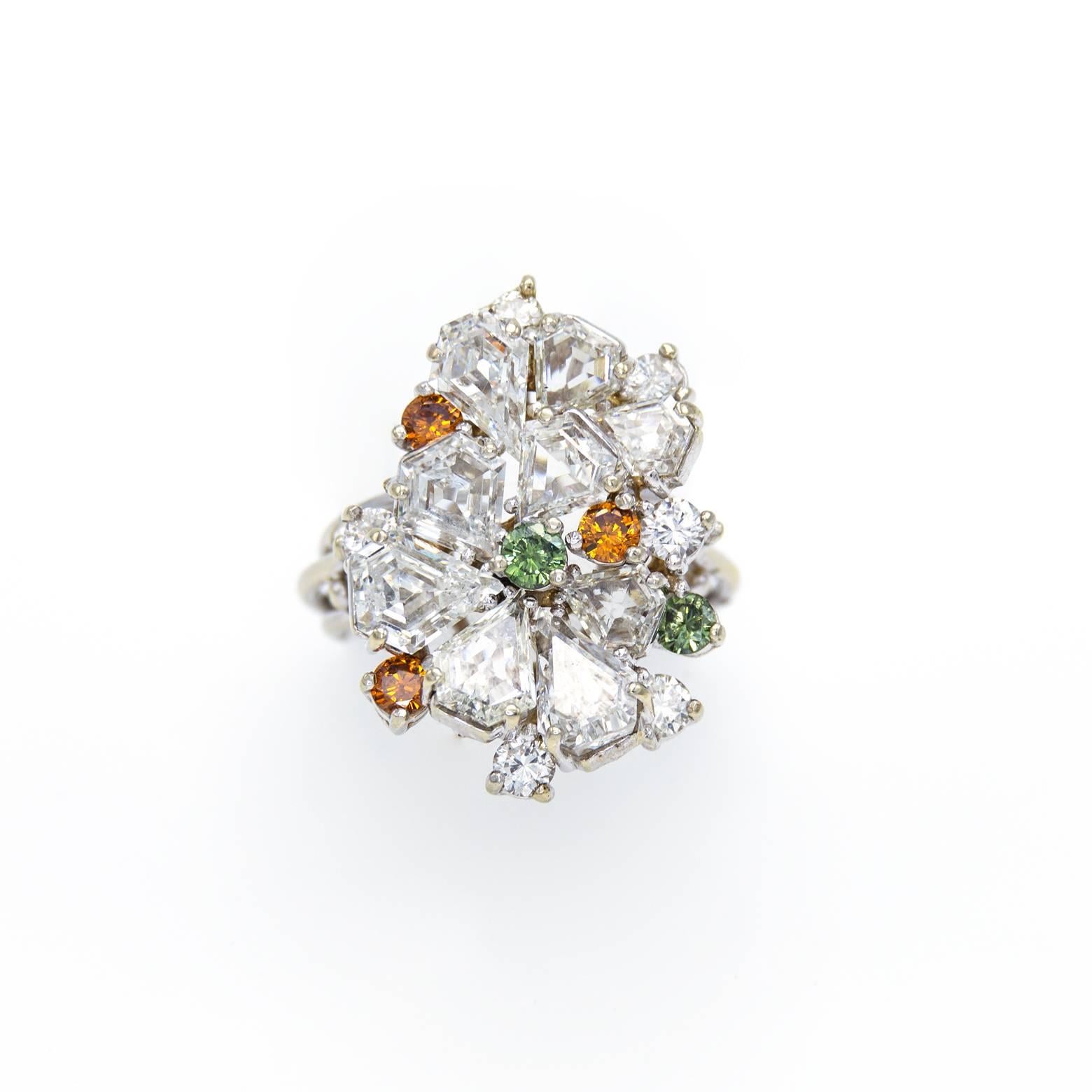 Wow this is a stunner of a ring. It has a multitude of teardrop white diamonds accented with green and yellow diamonds. The white gold setting accentuates the sparkle and clarity of the stones.The total effect is dazzling size 6 1/2. 
The ring size