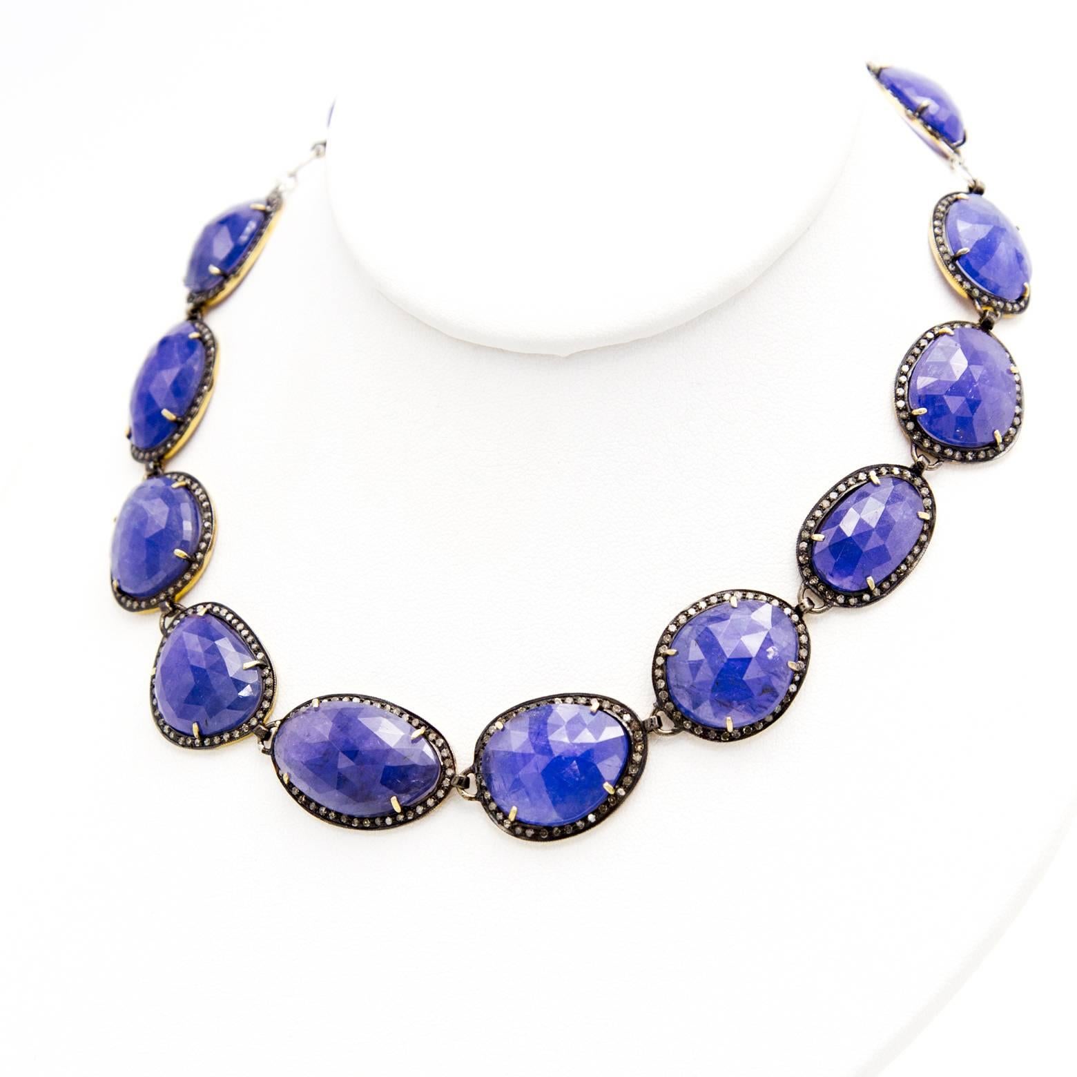 Large gorgeous tanzanites in many different varied shapes adorned with diamonds in a complimentary black oxidized sterling silver bezel. The tanzanites glow in their deep shade of purplish blue as if mined from the deep majestic ocean. Let yourself