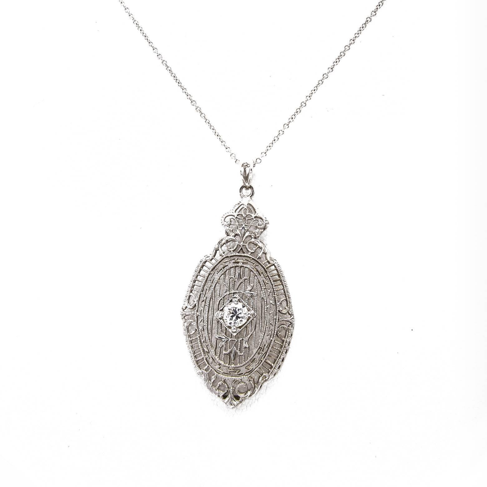 Lace-like and strong this quarter carat Diamond pendant glows with the delicate intricacy and excellent craftsmanship. Handmade in the 1920's when filigree was very popular the designer created a unique addition with a floral frame around the