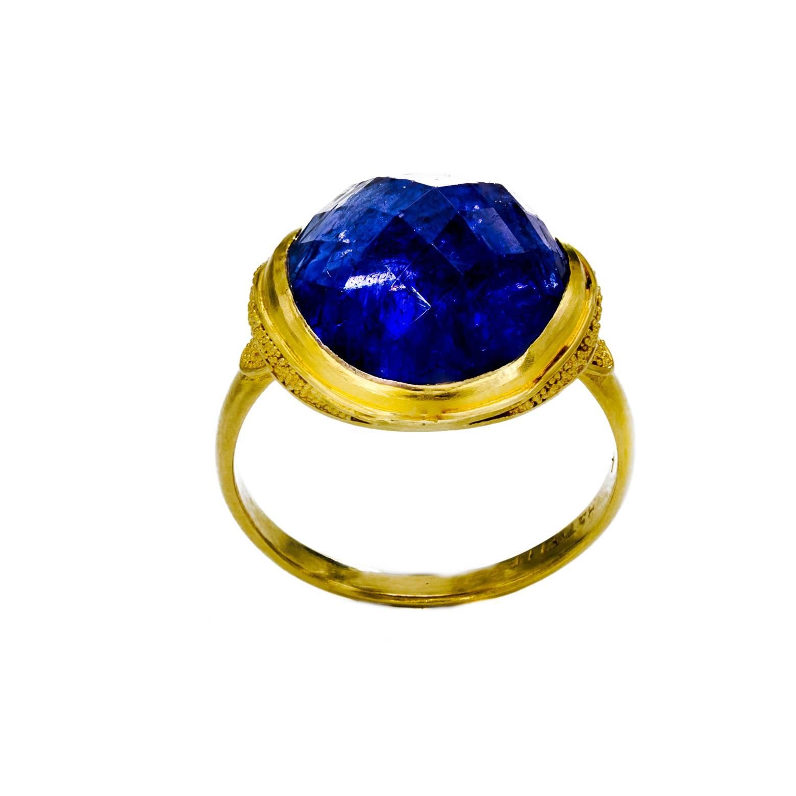 This stunning tanzanite ring has beautiful Balinese beading and gracefully holds the unusually cut tanzanite in a perfect cradle.A marvel of craftsmanship! The ring size is 7 1/4.