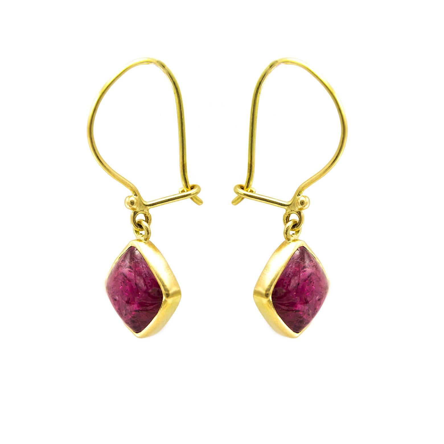 These bright pink tourmaline earrings are simple in design and the stones are absolutely gorgeous. The 18K yellow gold bezel holds these earring in a brilliant  manner so that the stones and swing and sway to capture and reflect more light. 