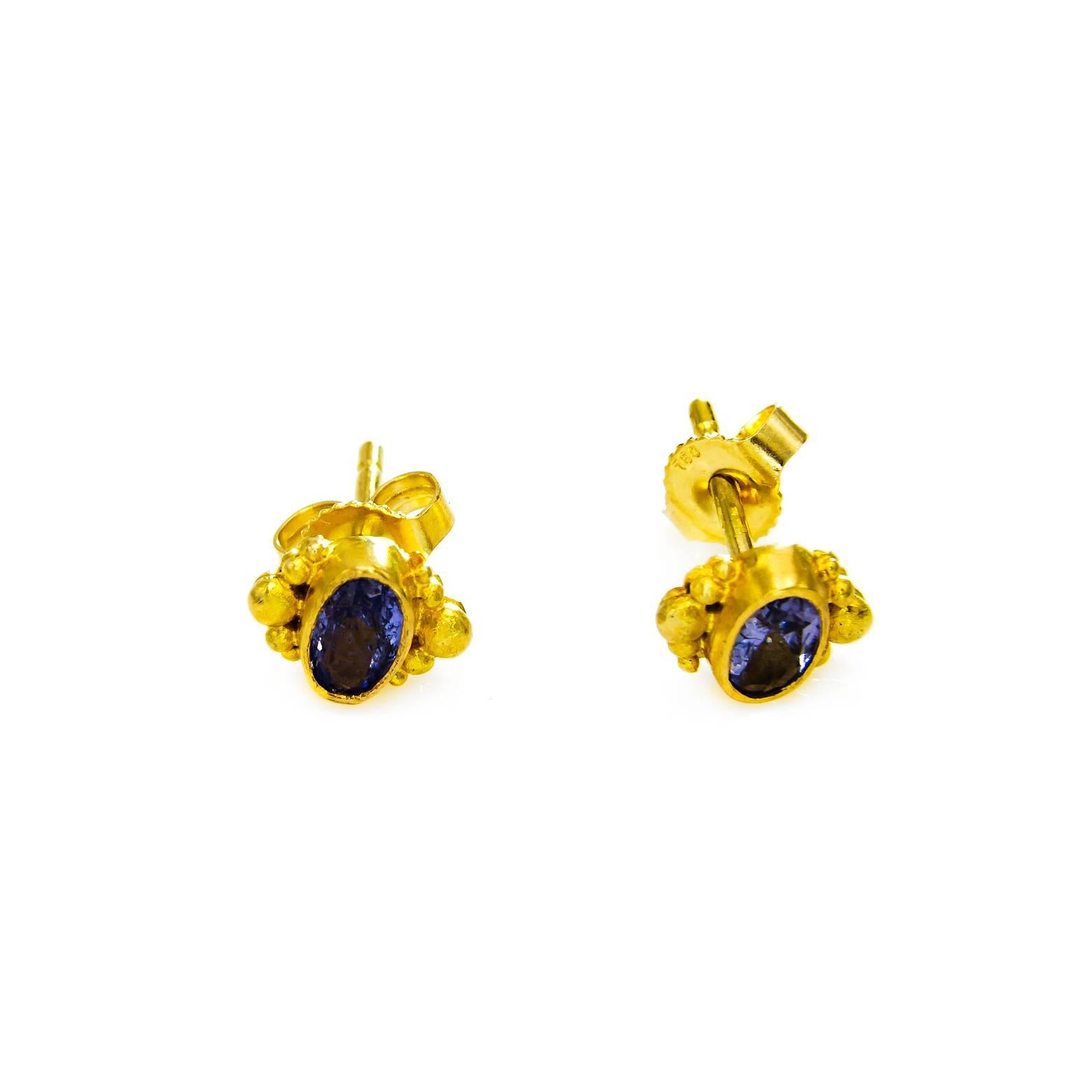 These artistic post beauties glow with rose cut indigo oval tanzanite embellished in gorgeous satin finished 18K yellow gold. Easy and comfortable to wear these post studs are stunning, elegant, and contemporary.