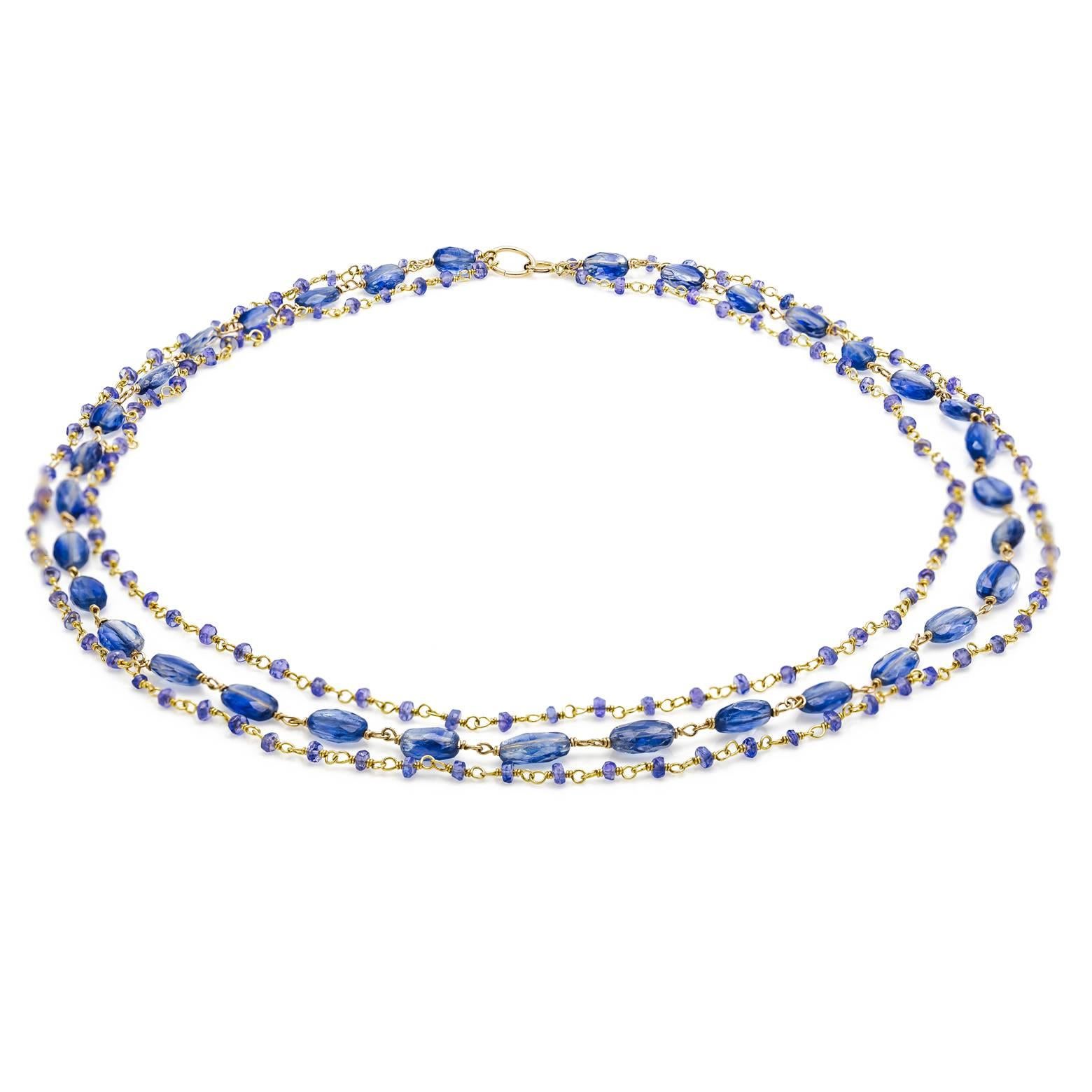 Delicate and artistic this intriguing necklace is made of 3 strands of indigo tanzanites and kyanites. The largest strand has 33 oval faceted kyanite beads. Easily dressed up and fun enough to wear everyday the deep ocean blue is calming and adds