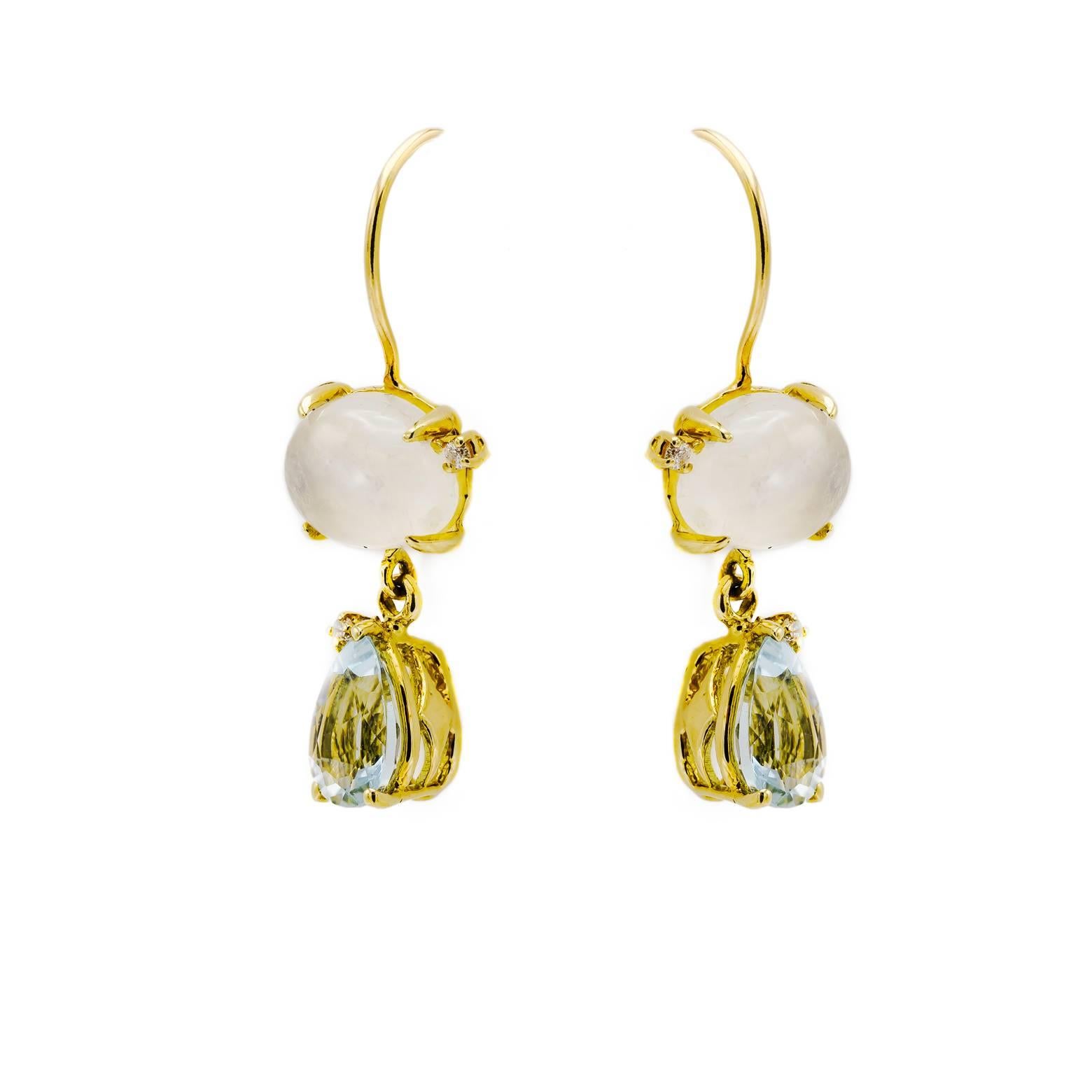 These stunning and elegant earrings are oval moonstones with faceted pear aquamarines decorated and four diamonds. 18K Yellow Gold create the perfect bezel and frame for these dangle drop earrings. 
