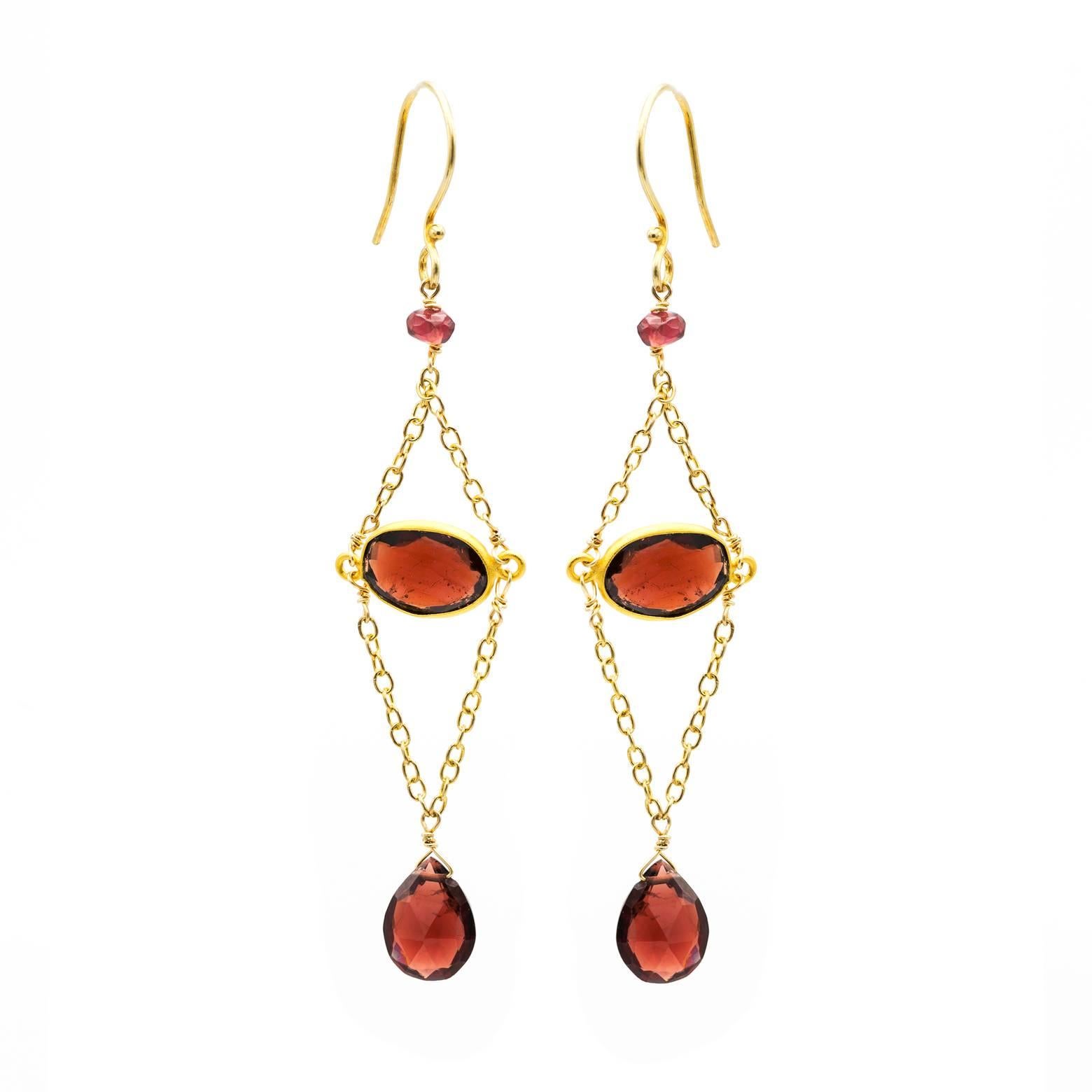 These long and elegant garnet earrings are festive and bright! Facets on all beads are decorated and embellished with gold chains as they swing and capture the cinnamon tainted light. Gorgeous and beautiful!