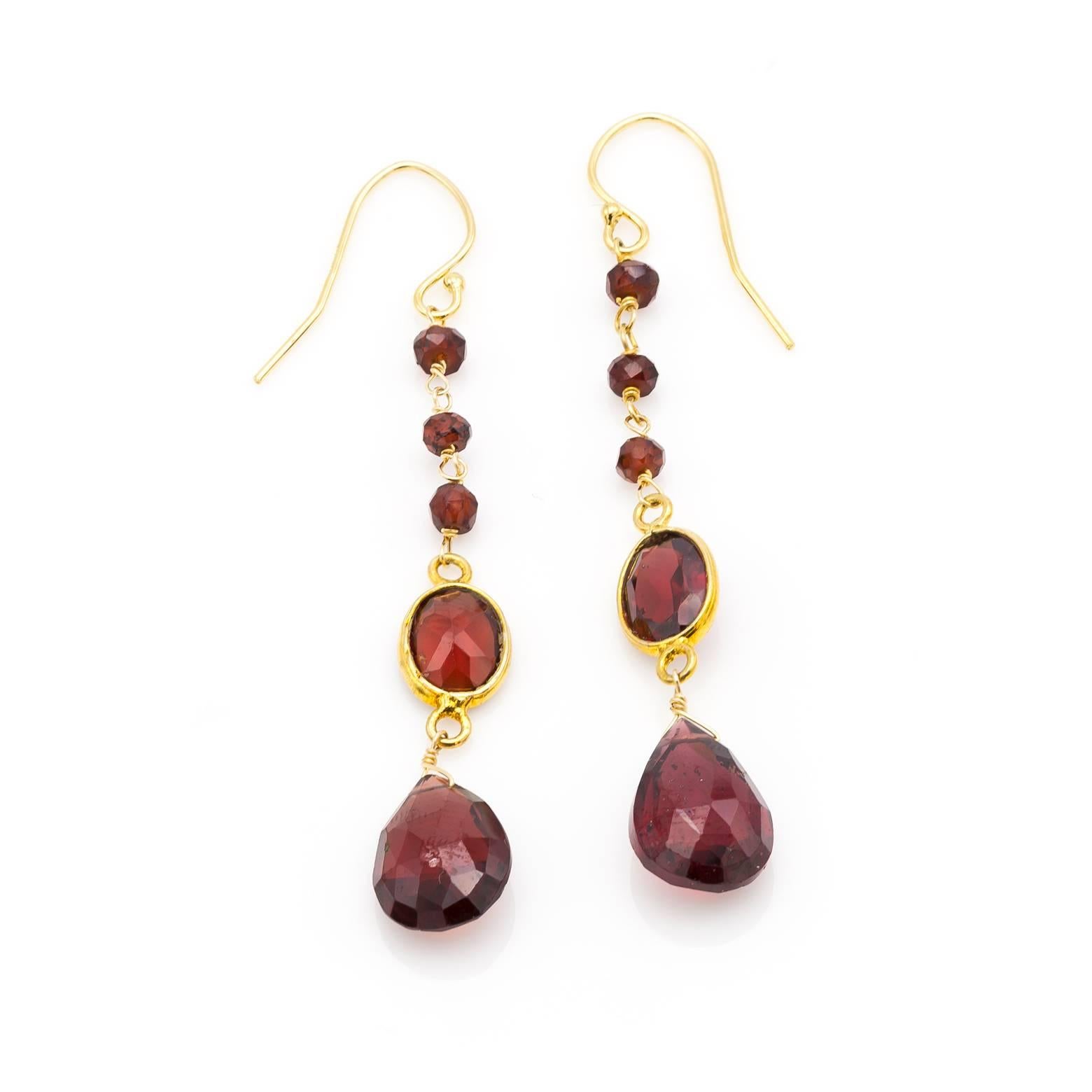 Ten garnets total in these beautiful January birth stone earrings. All faceted crimson garnets in a rich juicy red color held in a beautiful gold. Let the warmth of this stunning color swing and sway while they add elegance and style to your