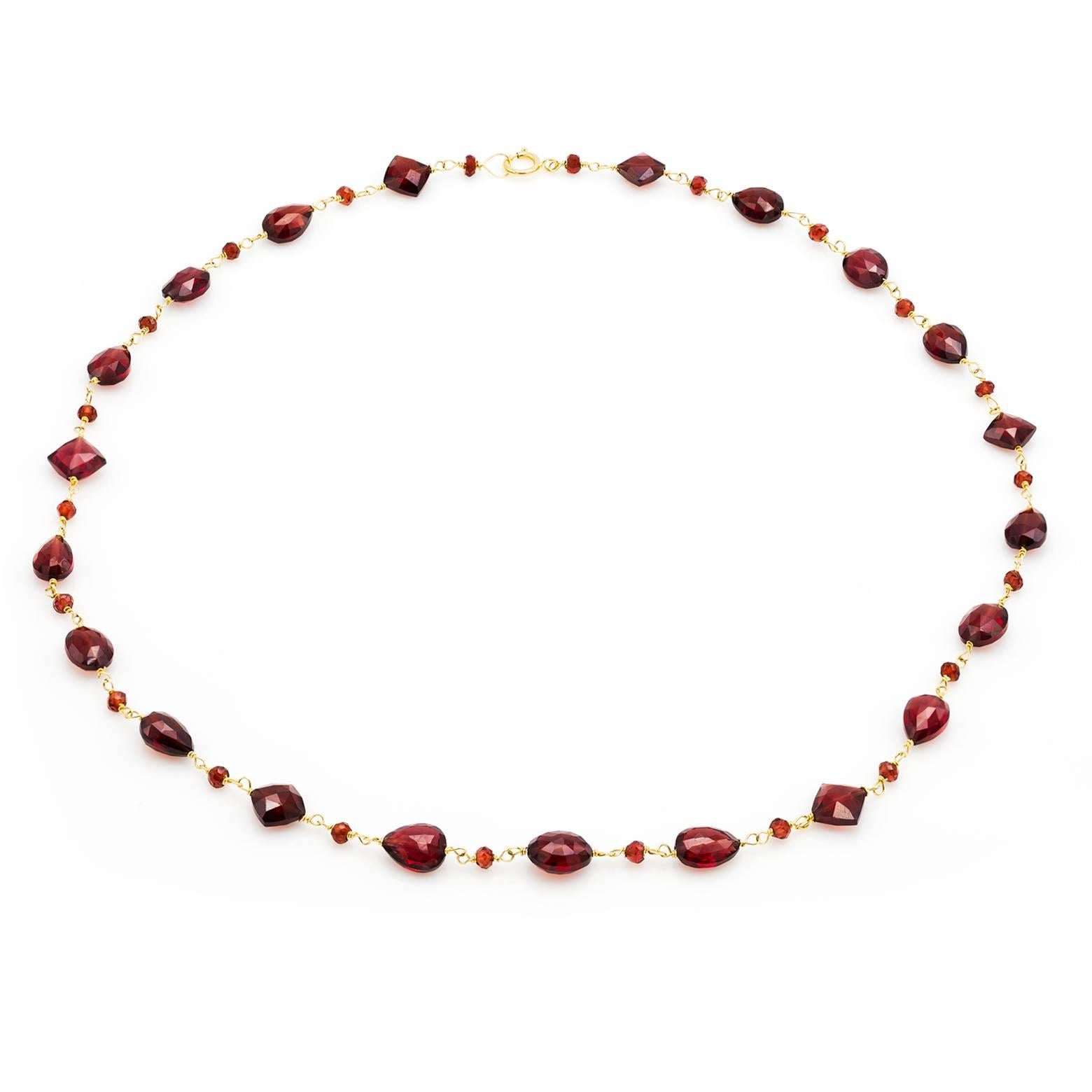 Beautiful shapes of faceted garnets create this bright fire red garnet necklace. Briolettes, ovals, and faceted square beads are connected together with smaller alternating beads creating a sophisticated and elegant look. Easily dressed up or down