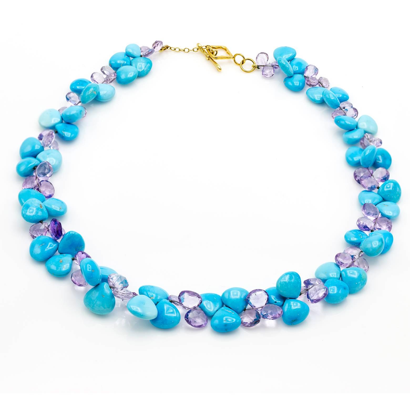 Flowers of turquoise and faceted amethyst briolettes create this bright and stunning necklace. The turquoise is a light ocean blue as if staring into the Caribbean and the amethysts are a light sparkly mystical purple. A substantial weight with an