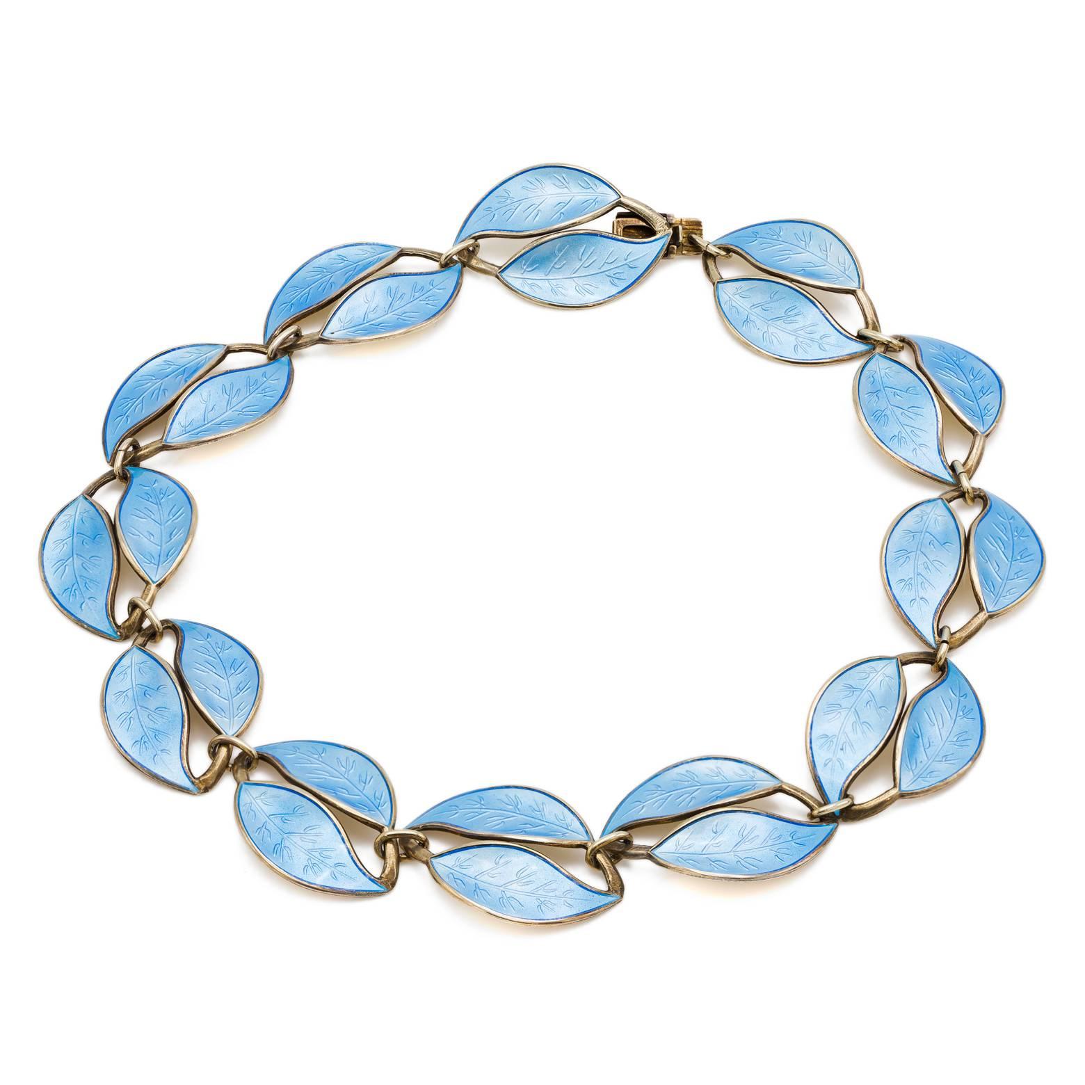 This stunning light blue Guilloche enamel necklace is made of leaves linked together in a delicate antique design. Set in sterling silver and a masterpiece! Inquire about our complete set. 