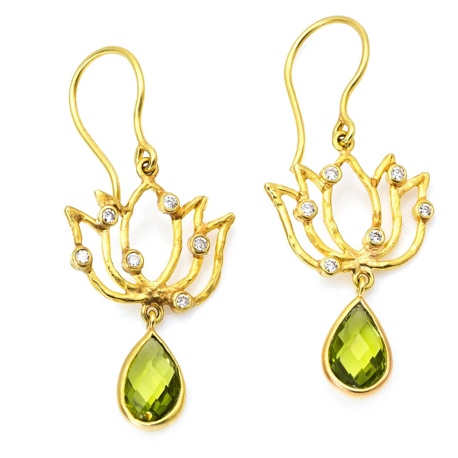Stunning and elegant drop earrings adorned with pear shaped peridots that swing from the bottom and dazzle with 12 accent diamonds! These serene beauties invoke the blessed essence of gorgeous golden lotuses. 