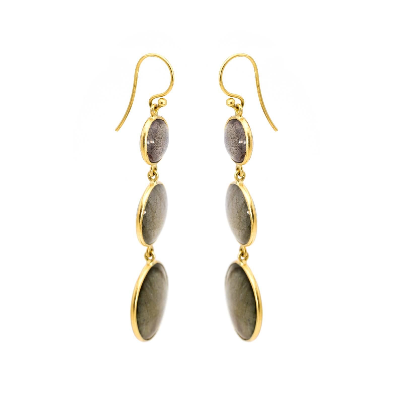 These labradorite earrings shine and sparkle like little galaxies swinging by your ear. They have the classic bright blue shine of labradorite and they also have a a glittery glow that looks like a million little stars. Set in 18K Yellow gold-