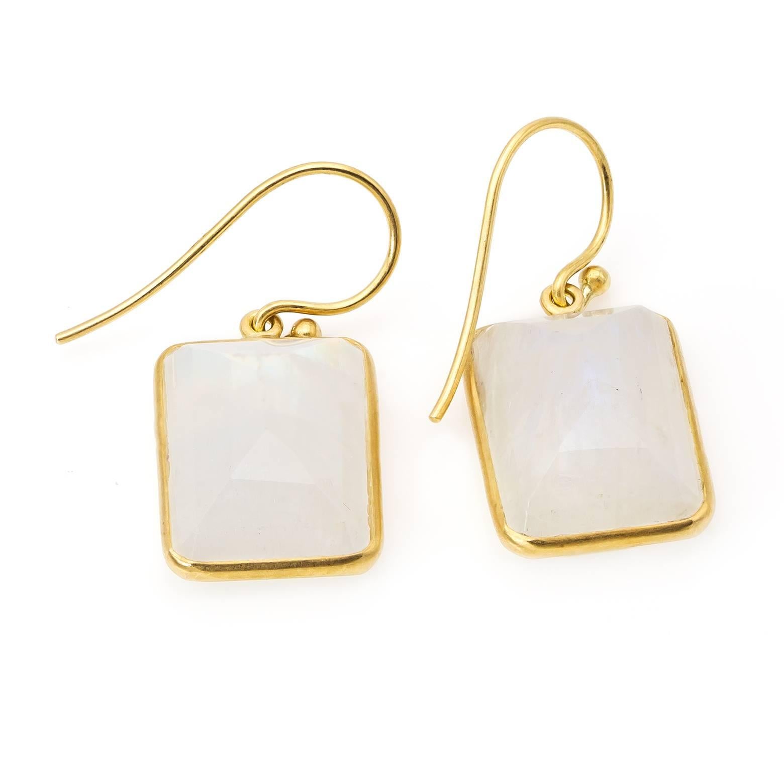 These dazzling white emerald-cut moonstone earrings glow and shine with depth of color and the cool blue labradoressence naturally found in moonstone.  Set in 18K yellow gold these substantial earrings offer an array of detail in classic white