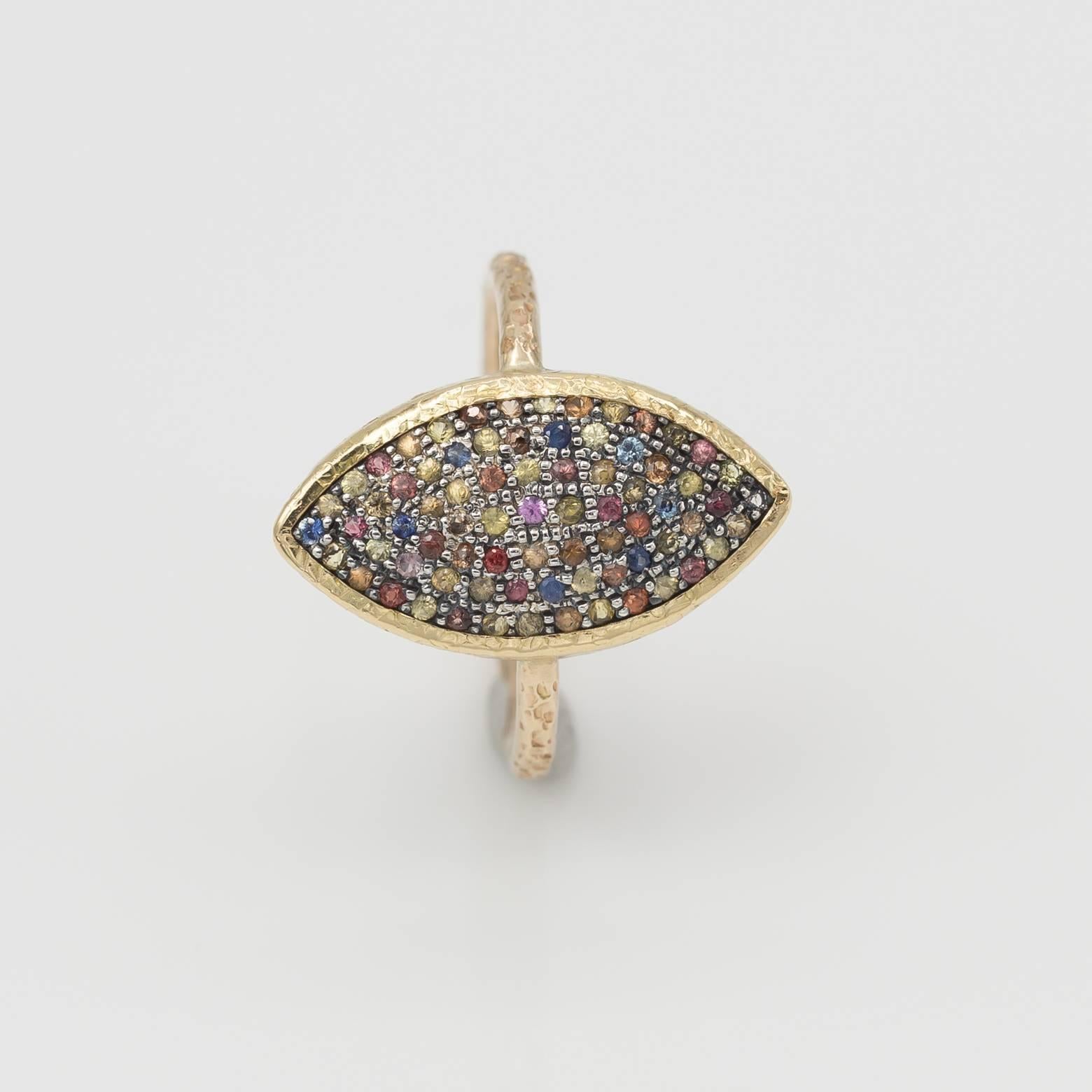 Dazzling sapphires in yellows, oranges, reds, blues, and pinks in a hammered 14K yellow gold bezel and band. This stained-glass window-like ring is held in sterling silver with points of dark oxidized sterling silver that adds brilliant contrast to