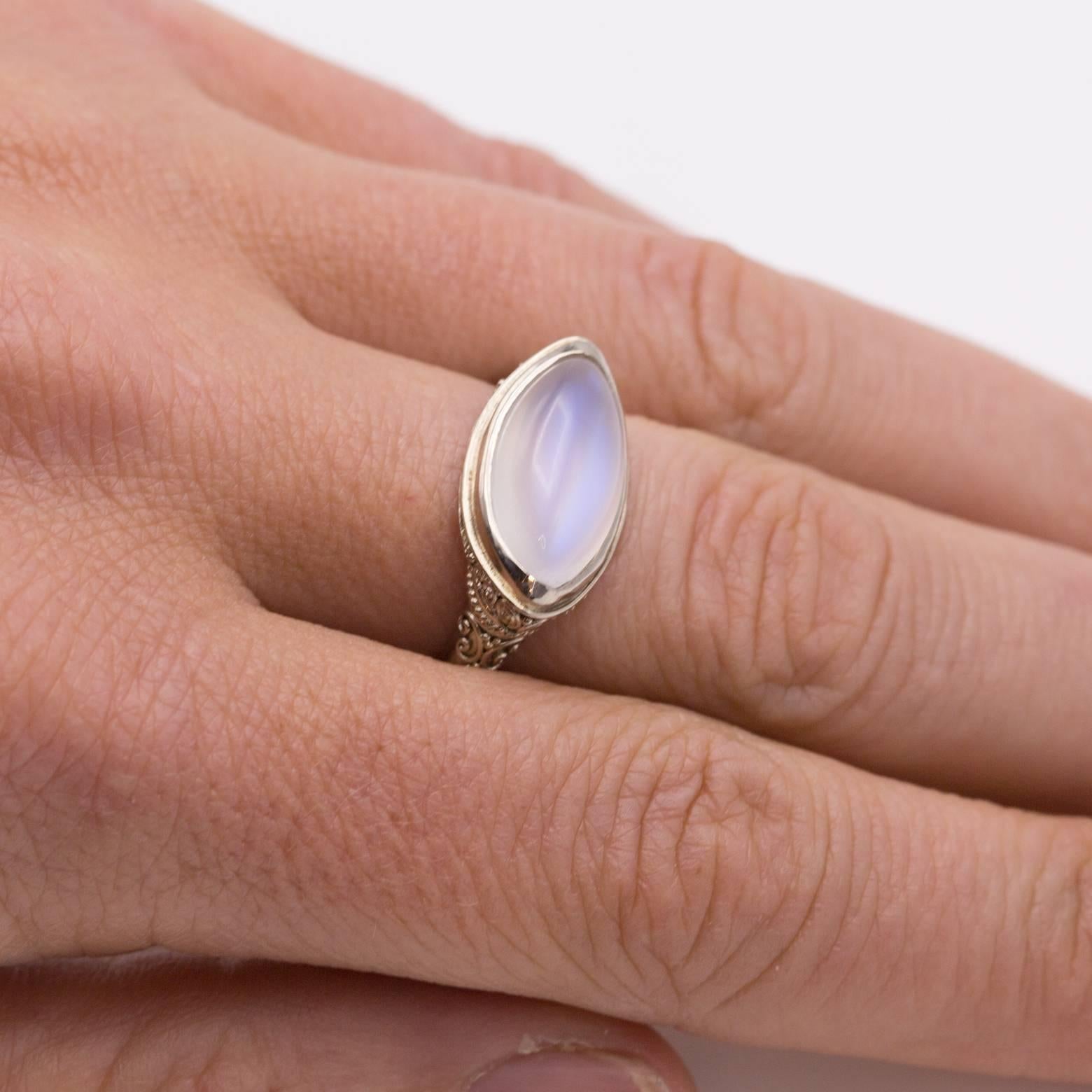 Intricate detail and a beautiful granular setting holds in this flawless marquise moonstone. The clarity almost looks as if it were a star sapphire but with the brightness of a white moonstone. Fashionable with the light blue/purple glow