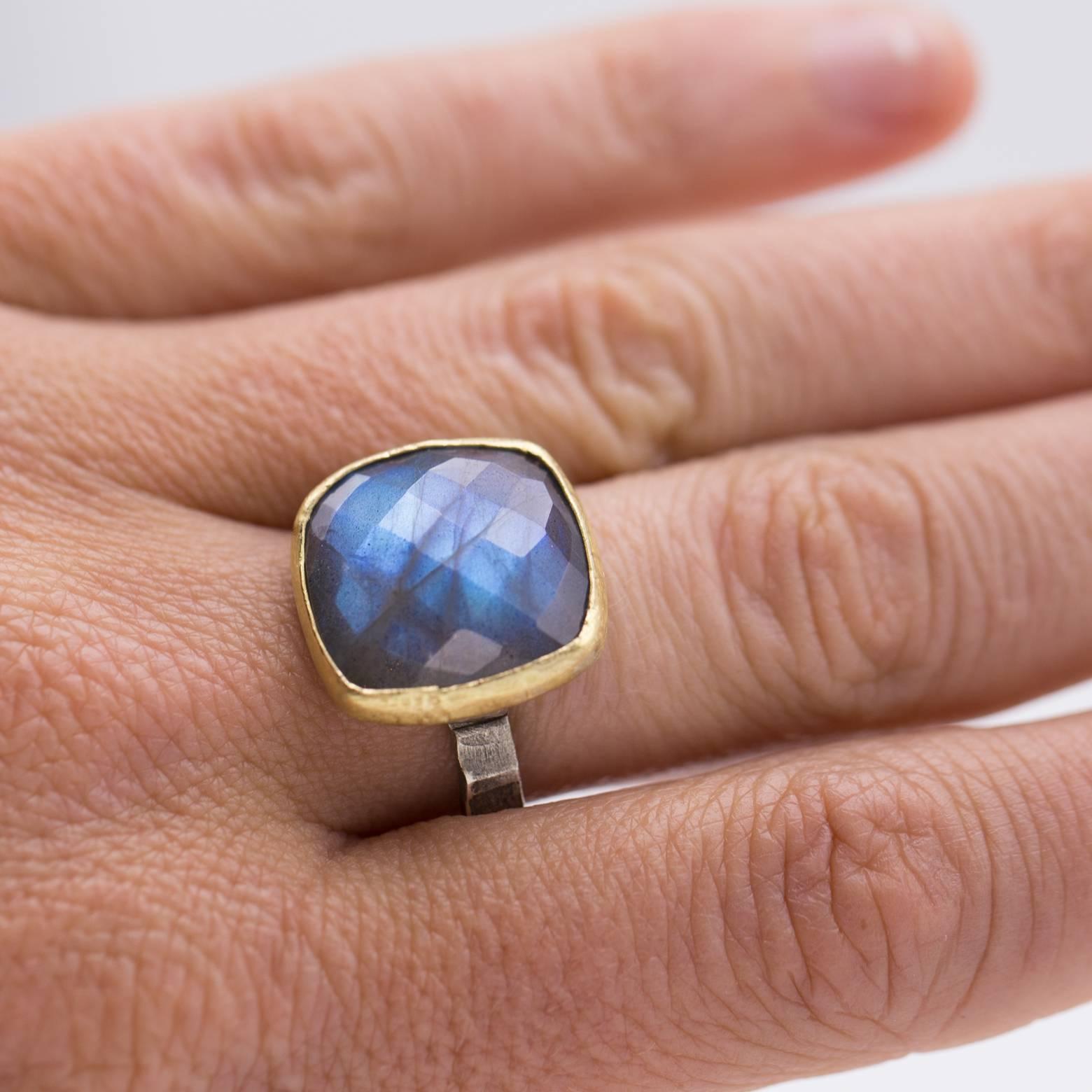 Glittery and gold, this large square labradorite ring is faceted in the checkerboard fashion and glows with it's signature labradoressence. A matte finish gold bezel with a thick textured sterling silver band. A size 8 and we can size it however you