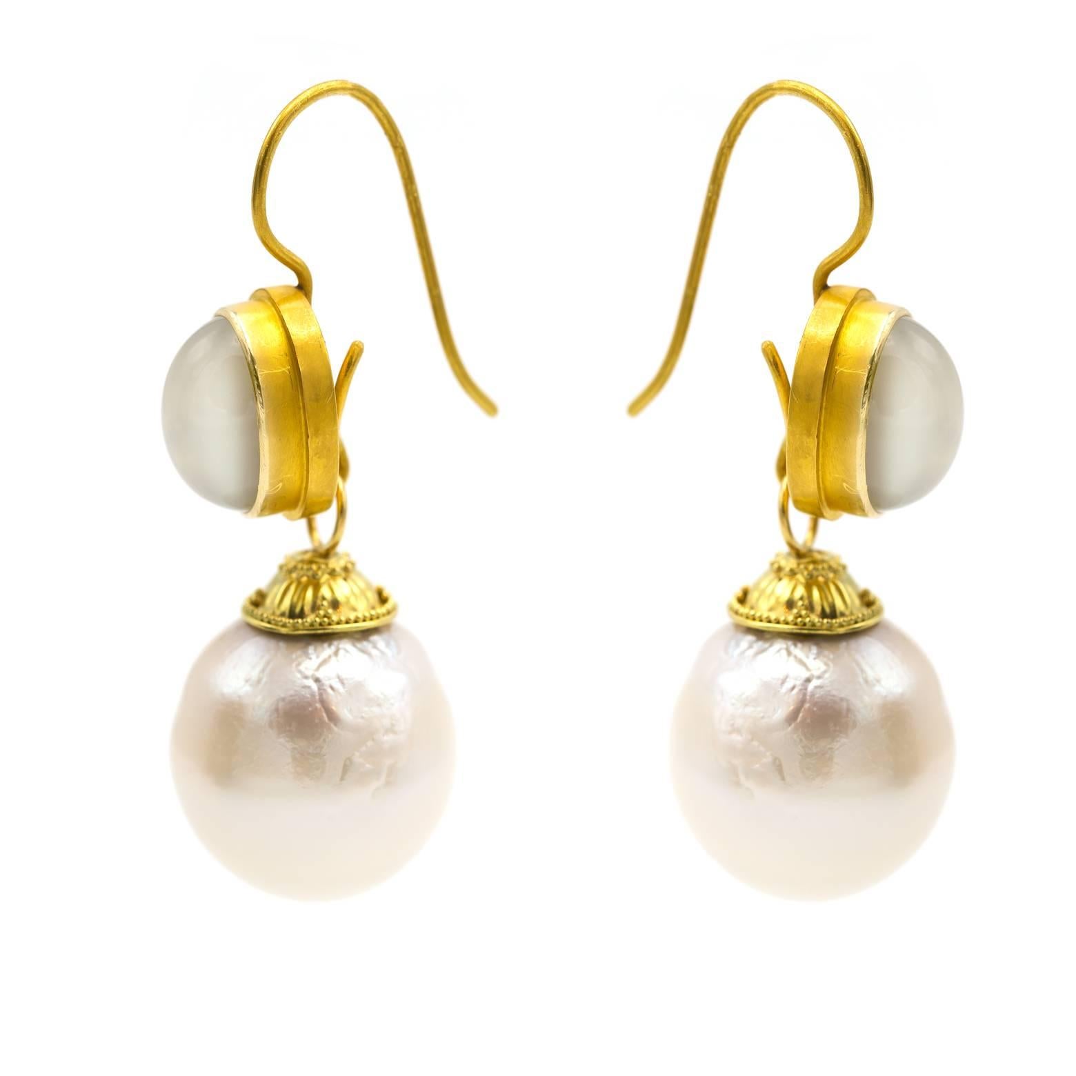These gorgeous fresh water pearl earrings shine with a light pink and ocean blue reflection while hanging from ethereal moonstone. Gold plated silver adds a hand-dipped texture to these earrings with a Venusian and regal style fit for a goddess! 