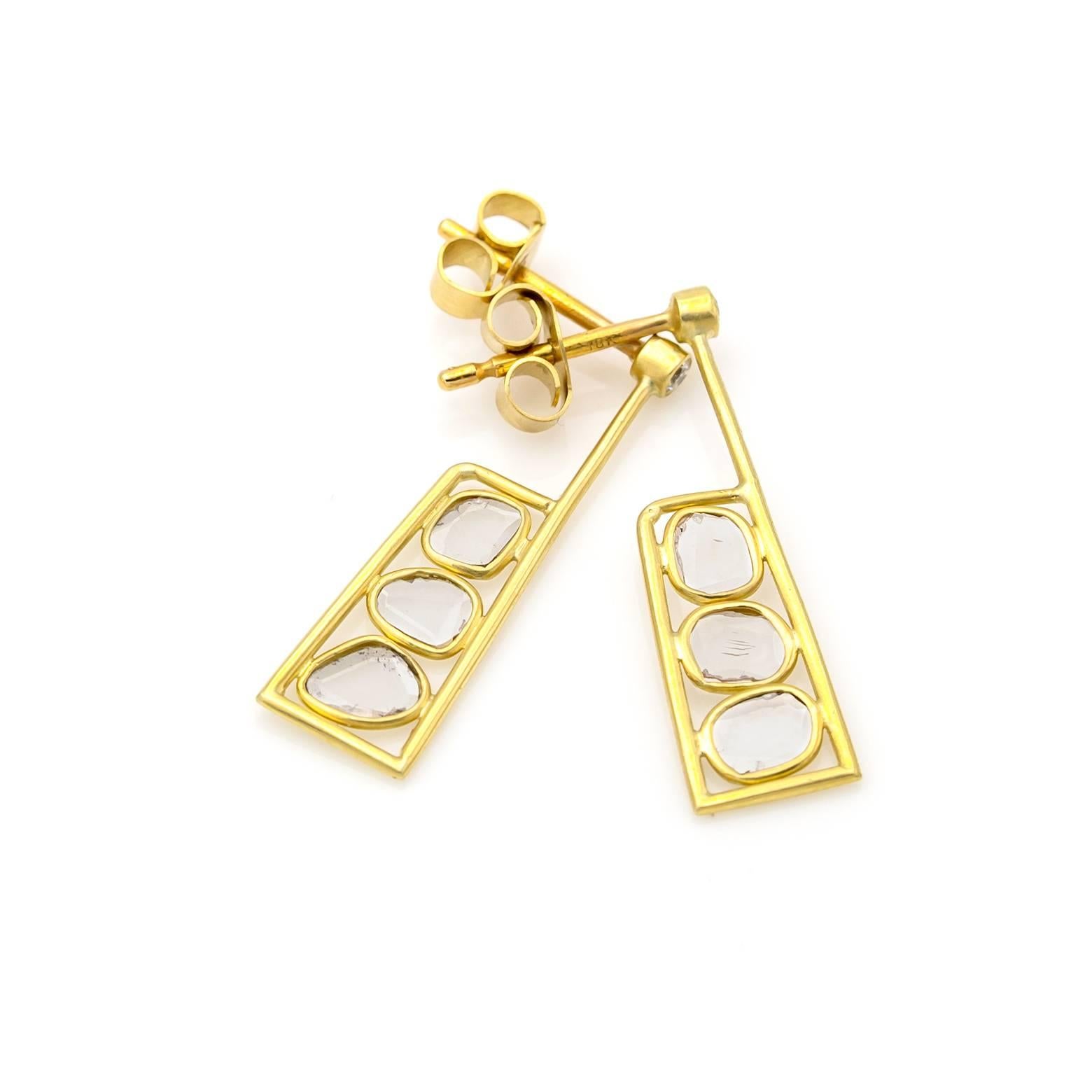 Organic rose cut diamonds are artistically set in 18K satin finished yellow gold with a white diamond on the post. A glimpse of sparkle in these earrings that can easily dress up any outfit!