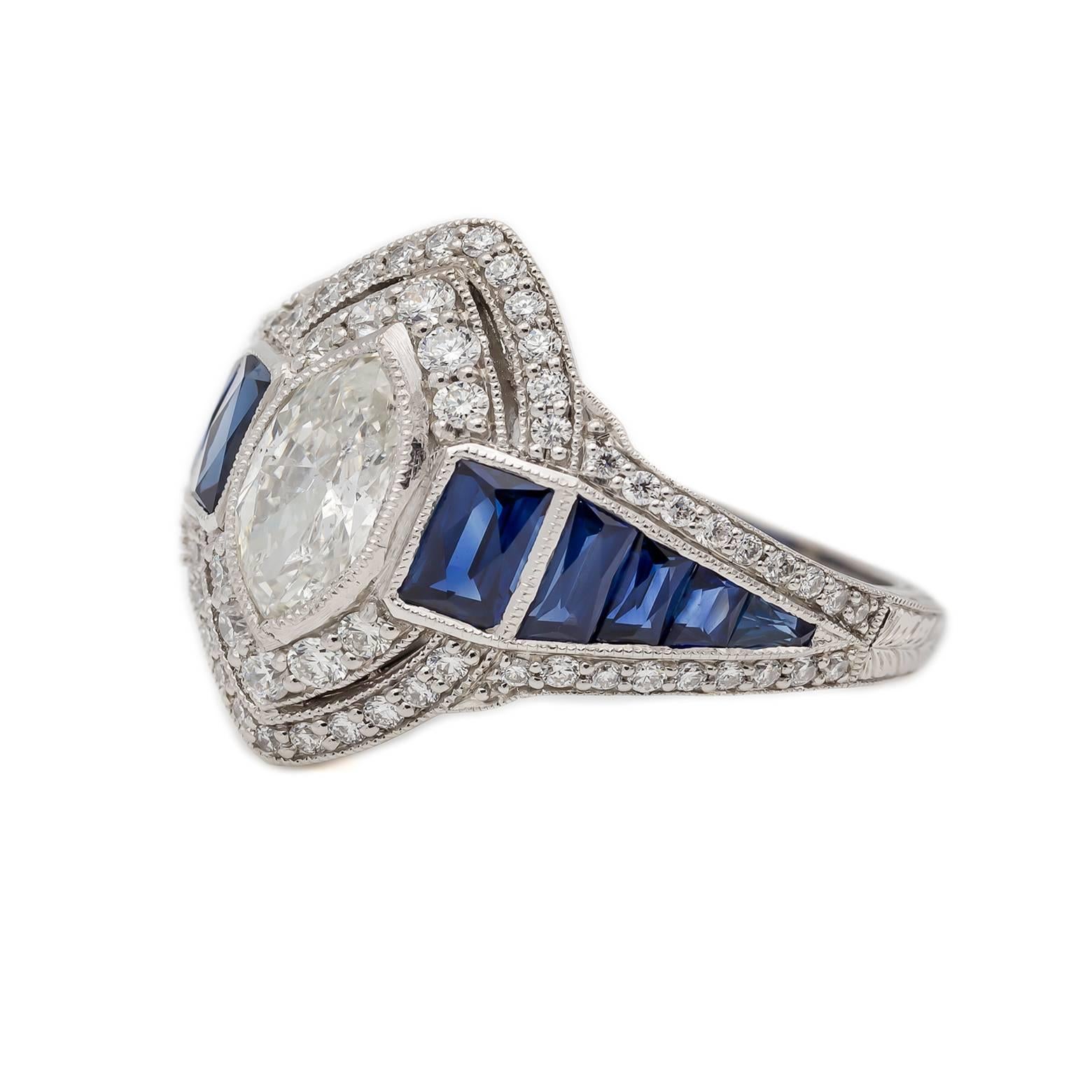As if from a grandiose Gatsby party! 1.02 carats of a Marquise Diamond centerpiece with 0.54 carats total weight Round Accent Diamonds. 0.68 carats total weight of Baguette Sapphires to compliment the brilliant design- an absolute stunner! Set in